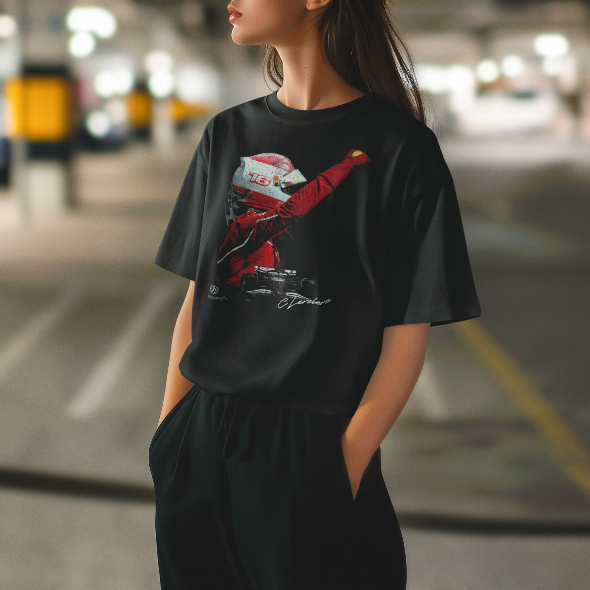 Person wearing a black t-shirt with a graphic design in an outdoor setting