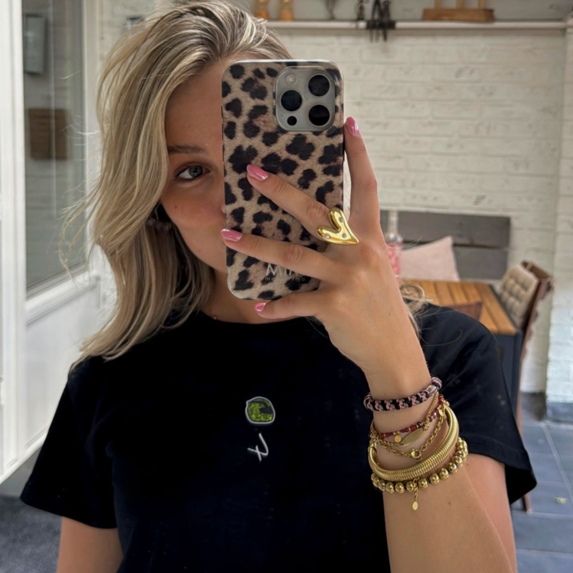 A black crop top with a carton image of Lando Norris's neon green and black helmut, with the number 4 in white below it.