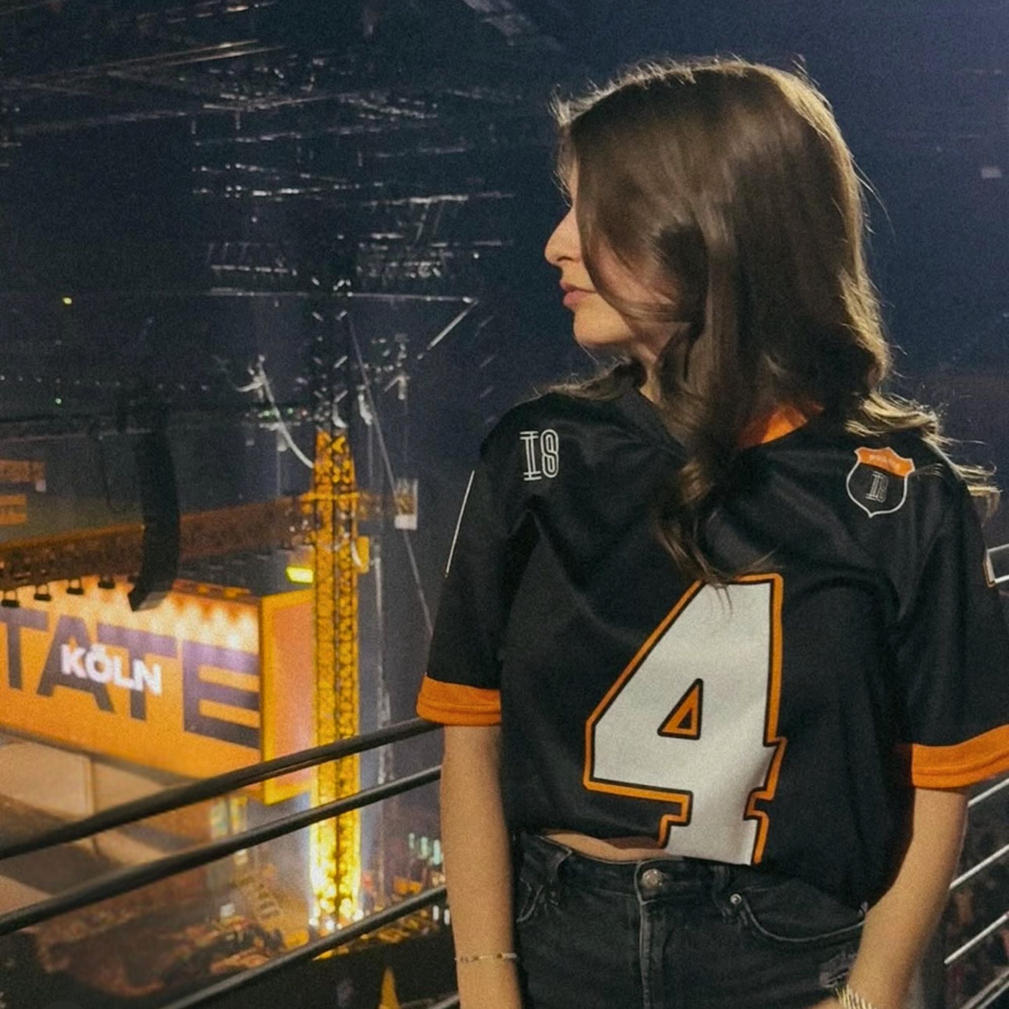 A black and papaya orange football jersey with Lando Norris's McLaren F1 racing number 4 on the back and front in white. It has the name Norris in orange on the front as well.