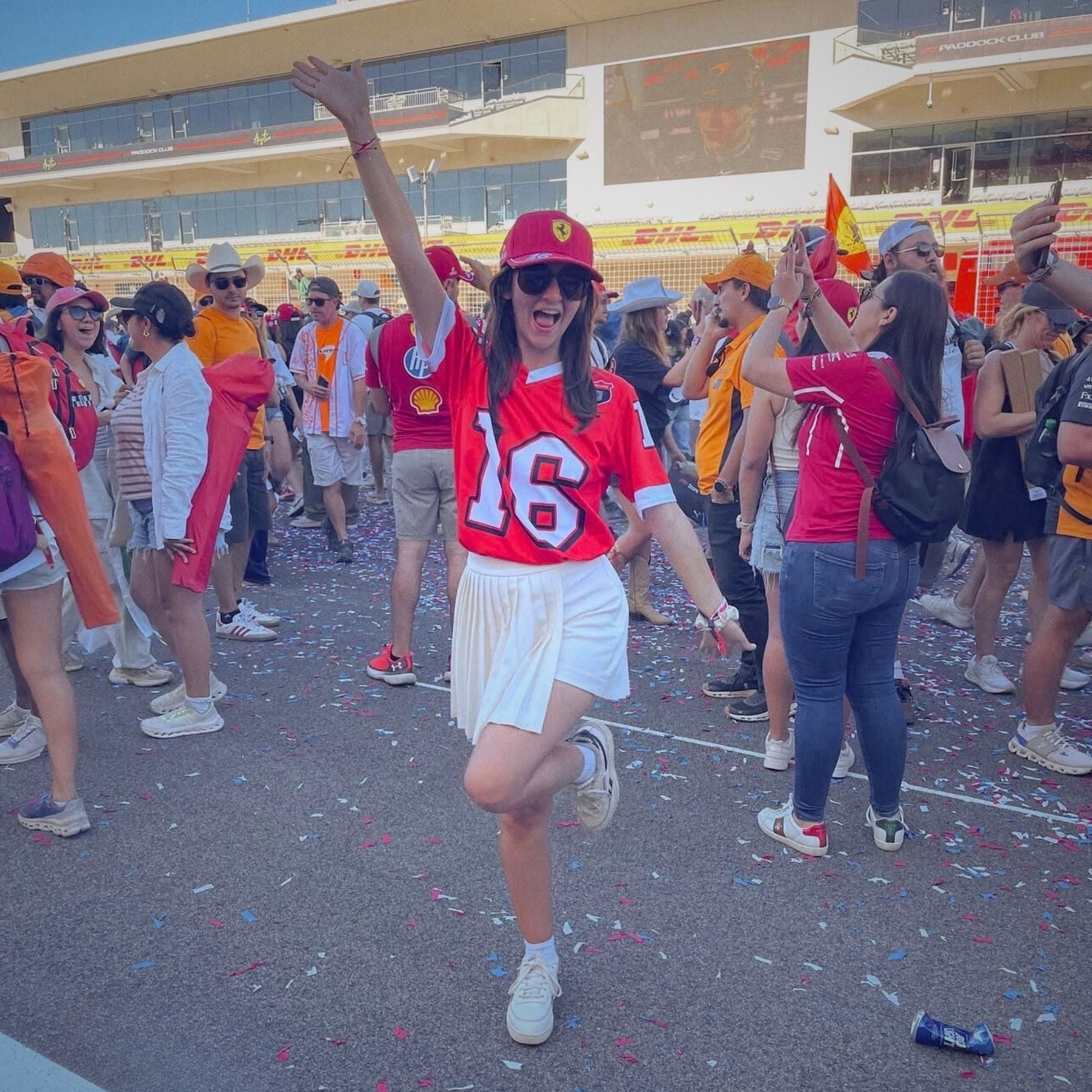 Person in red jersey with number 46 dancing in a crowd at an outdoor event.