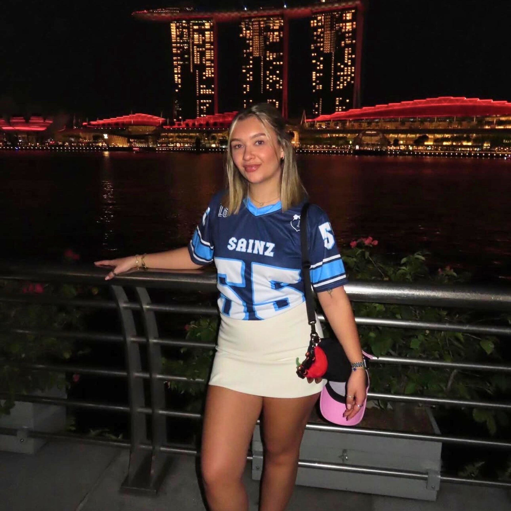 Woman wearing a sports jersey with a cityscape in the background