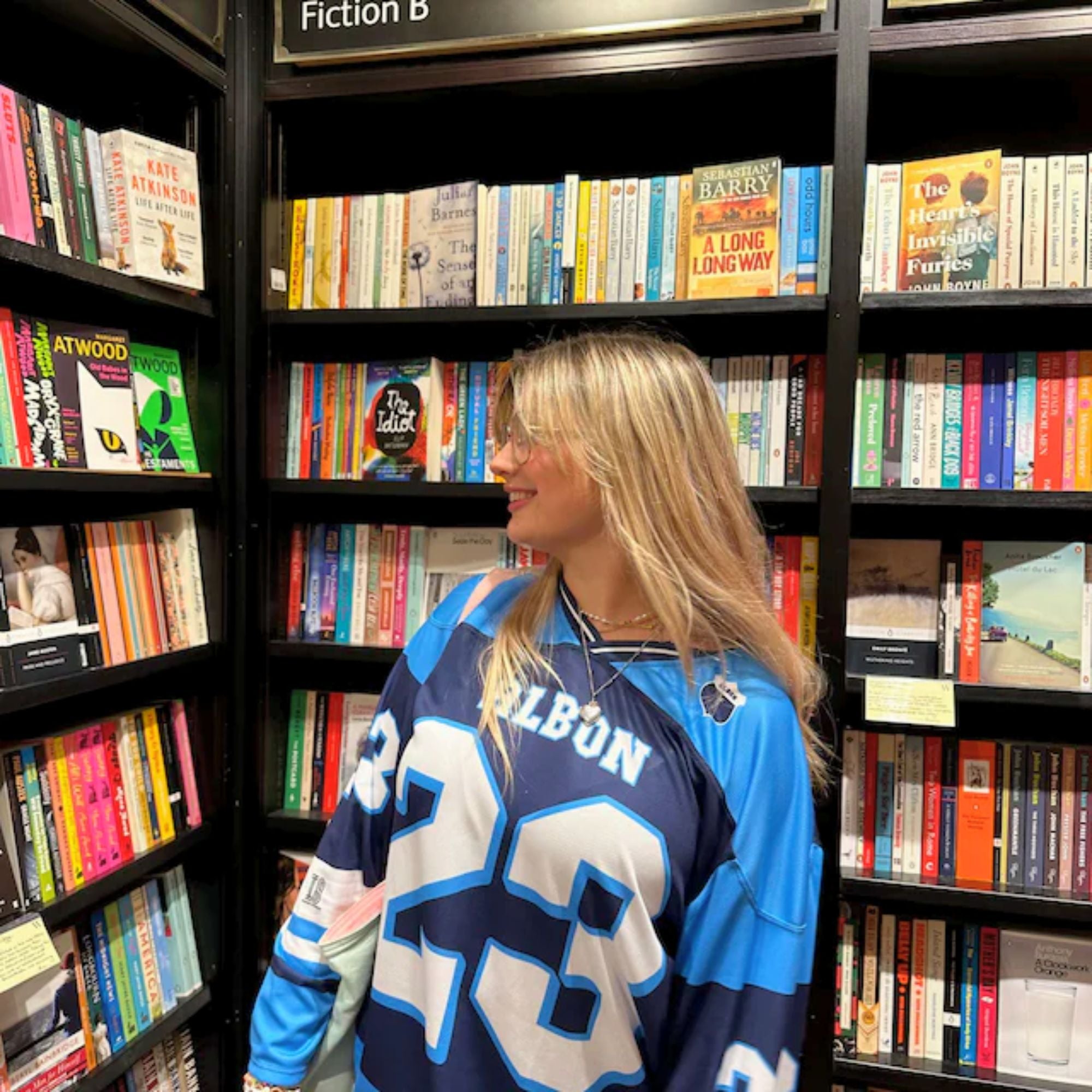 A blue hockey jersey with Alex Albon's Williams F1 racing number 23 on the front and back in white, also the name Albon is on the back and front in White.
