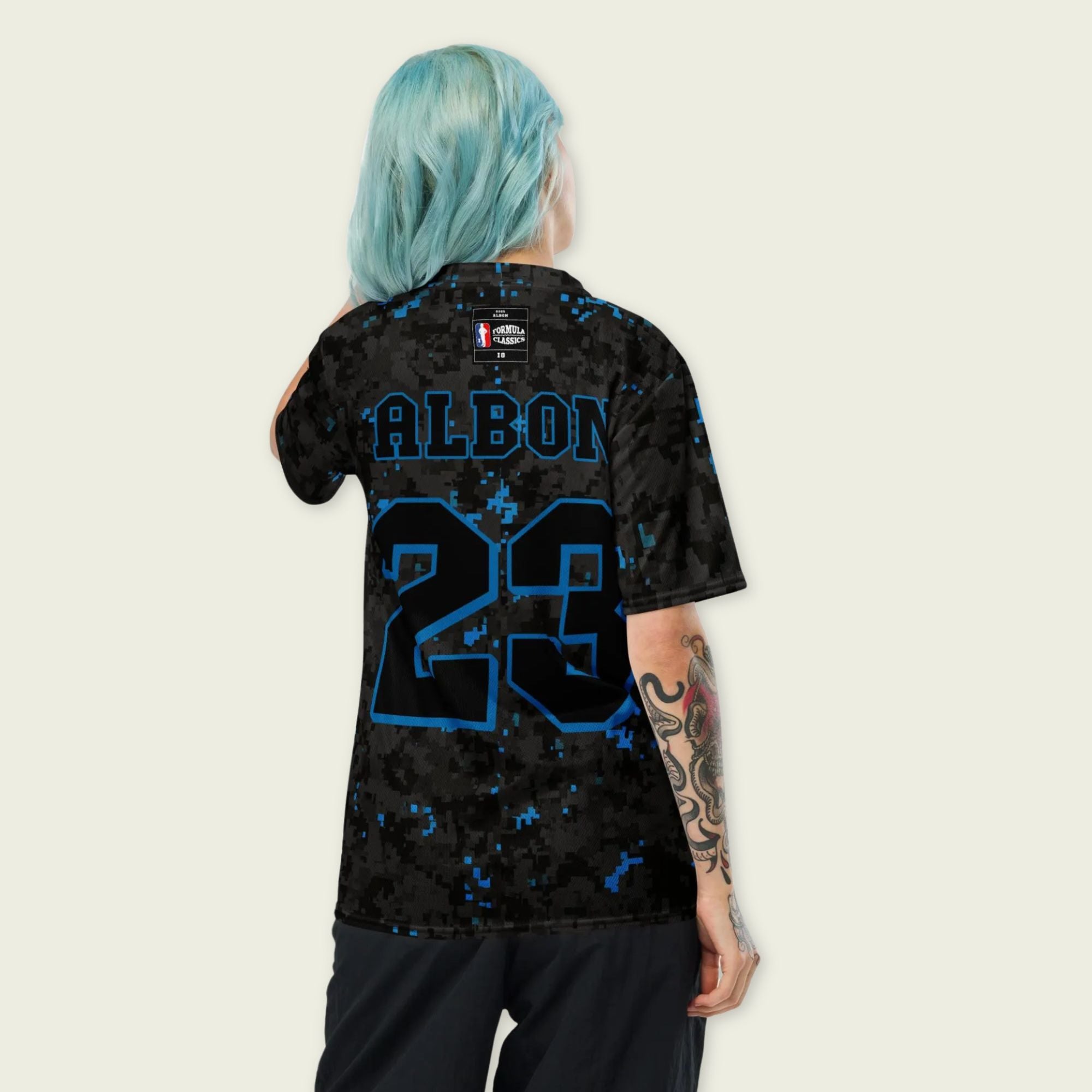 A camoflauge williams blue and black digital camo styled football jersey with  Alex Albons Williams F1 Racing number 23 on the front and back.