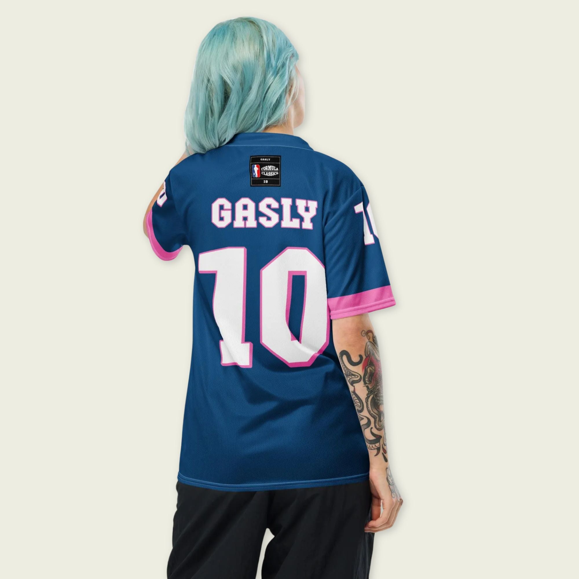 A blue and pink football jersey with Pierre Gasly' s Alpine F1 Racing number 10 on the front and back in white with a pink and black outline.