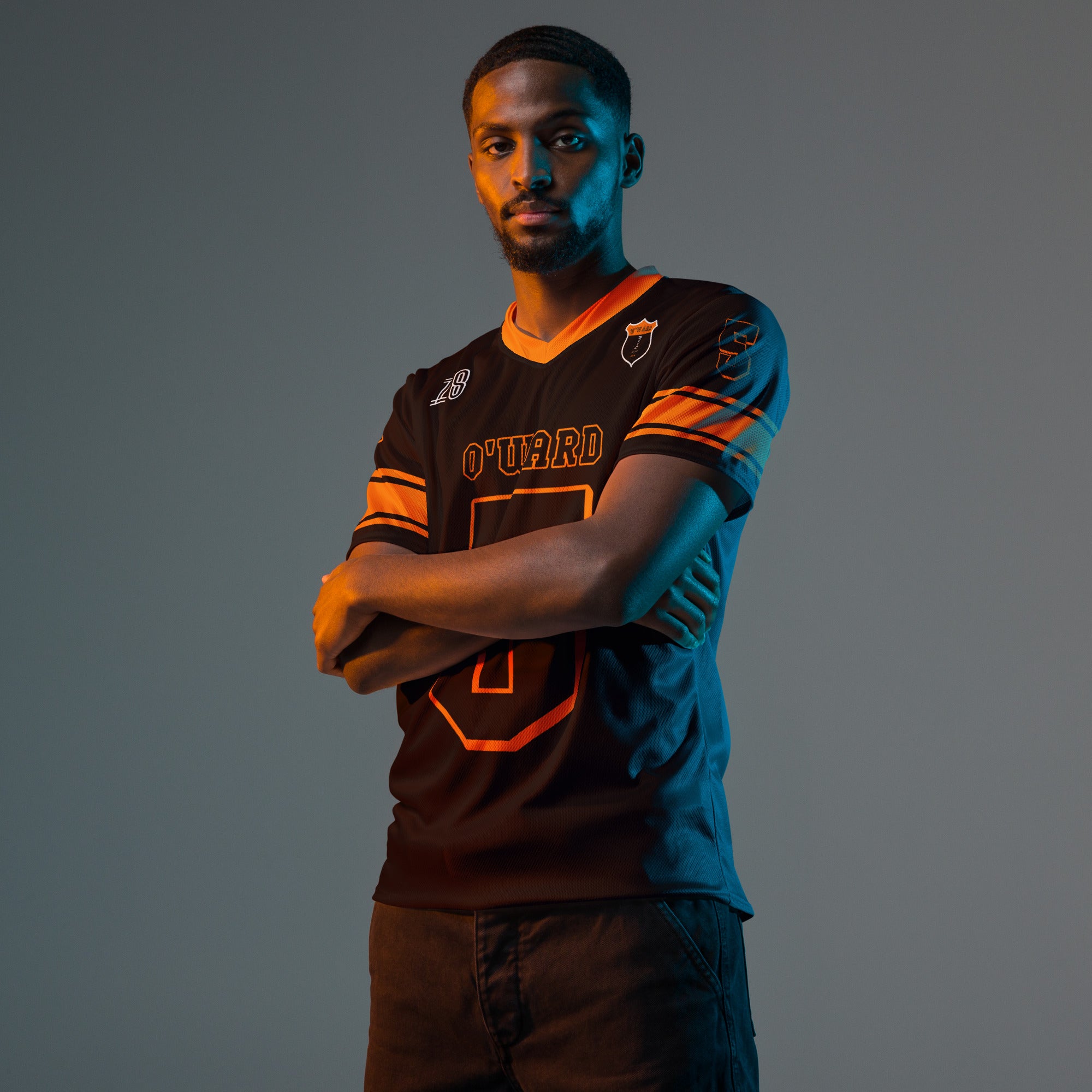 A black and orange football jersey with Pato O'Wards Arrow McLaren Indycar racing number 5 in orange. It has the name O'Ward on the front and back in orange as well.
