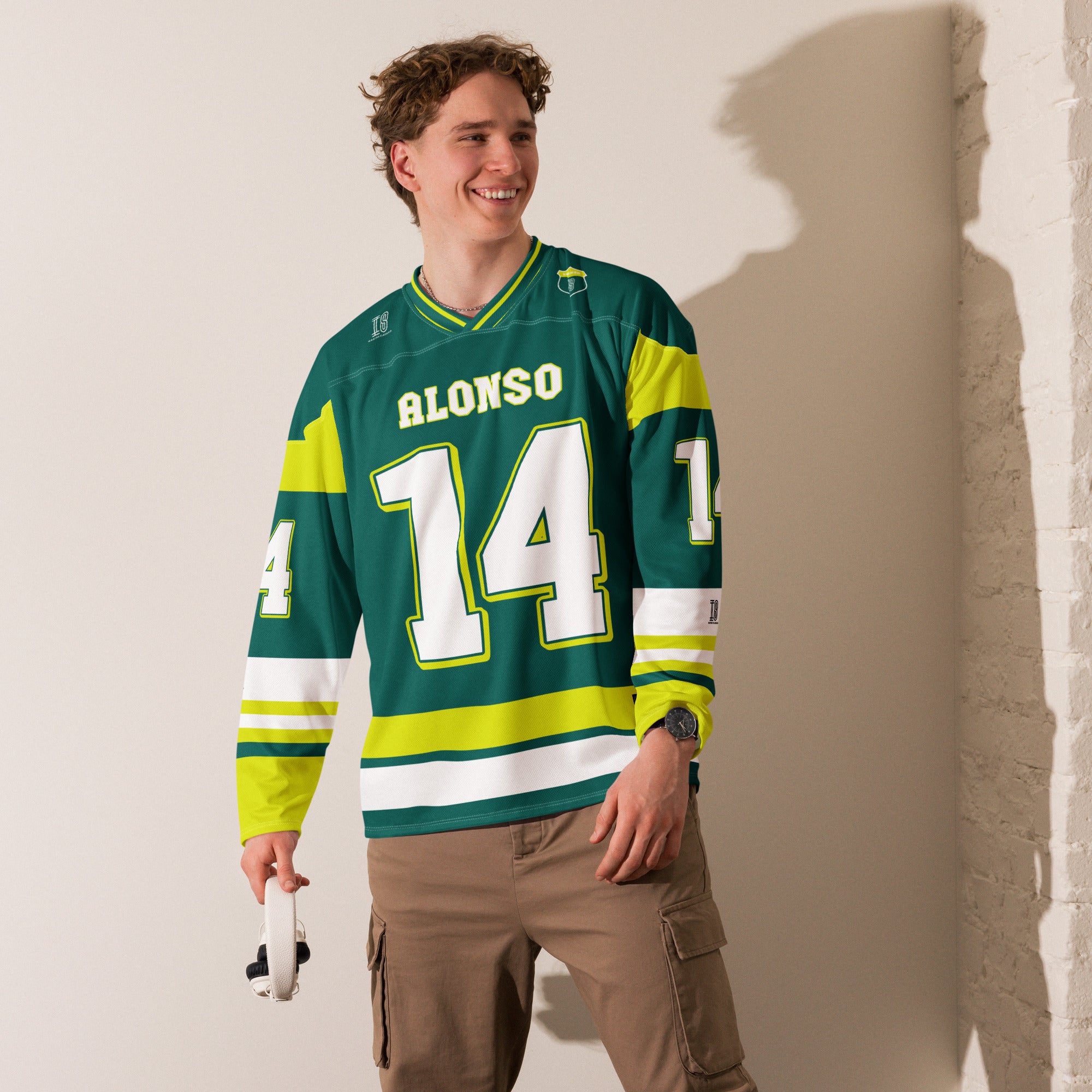 A British Green hockey jersey with Fernando Alonso's Aston Martin F1 racing number 14 in white on the front and back. It has the name Alonso on the back and front in white as well.