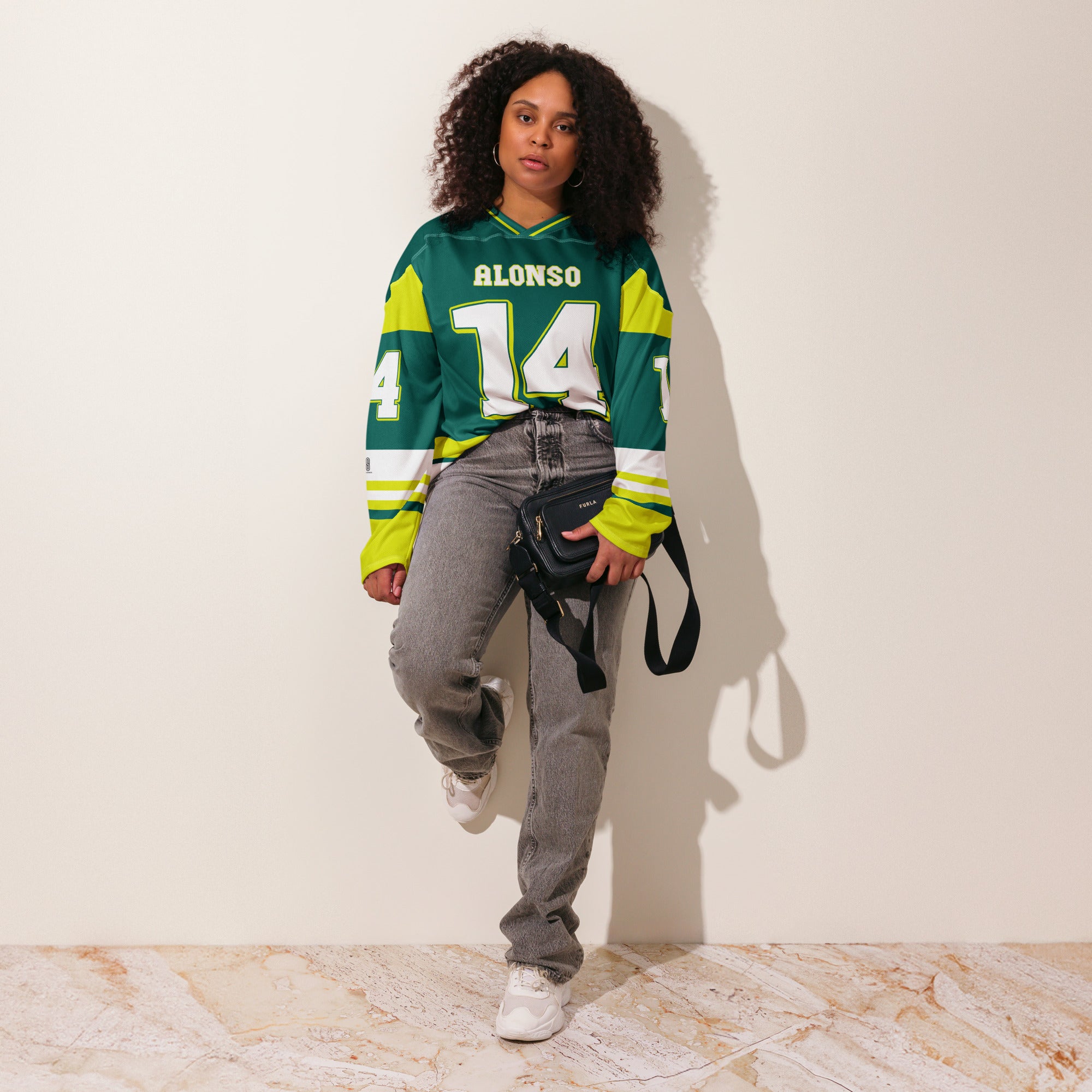 A British Green hockey jersey with Fernando Alonso's Aston Martin F1 racing number 14 in white on the front and back. It has the name Alonso on the back and front in white as well.
