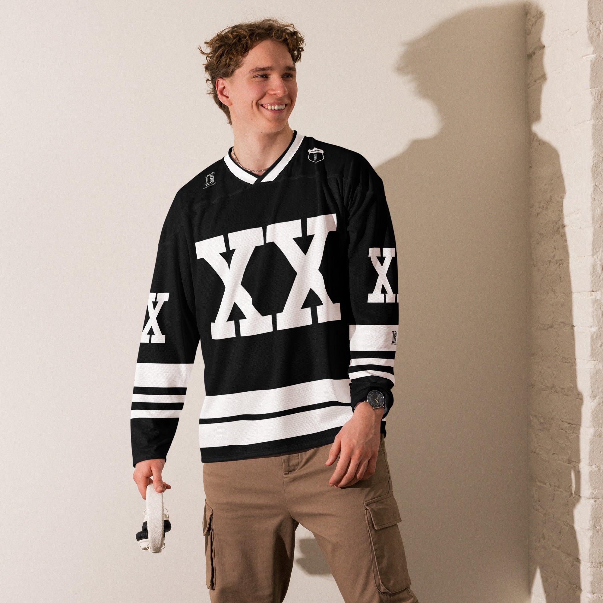 A Chris Brown Breezy Bowl Tour black and white hockey jersey with white lines showing the name Breezy on black on the back and XX on the front and back in white also.