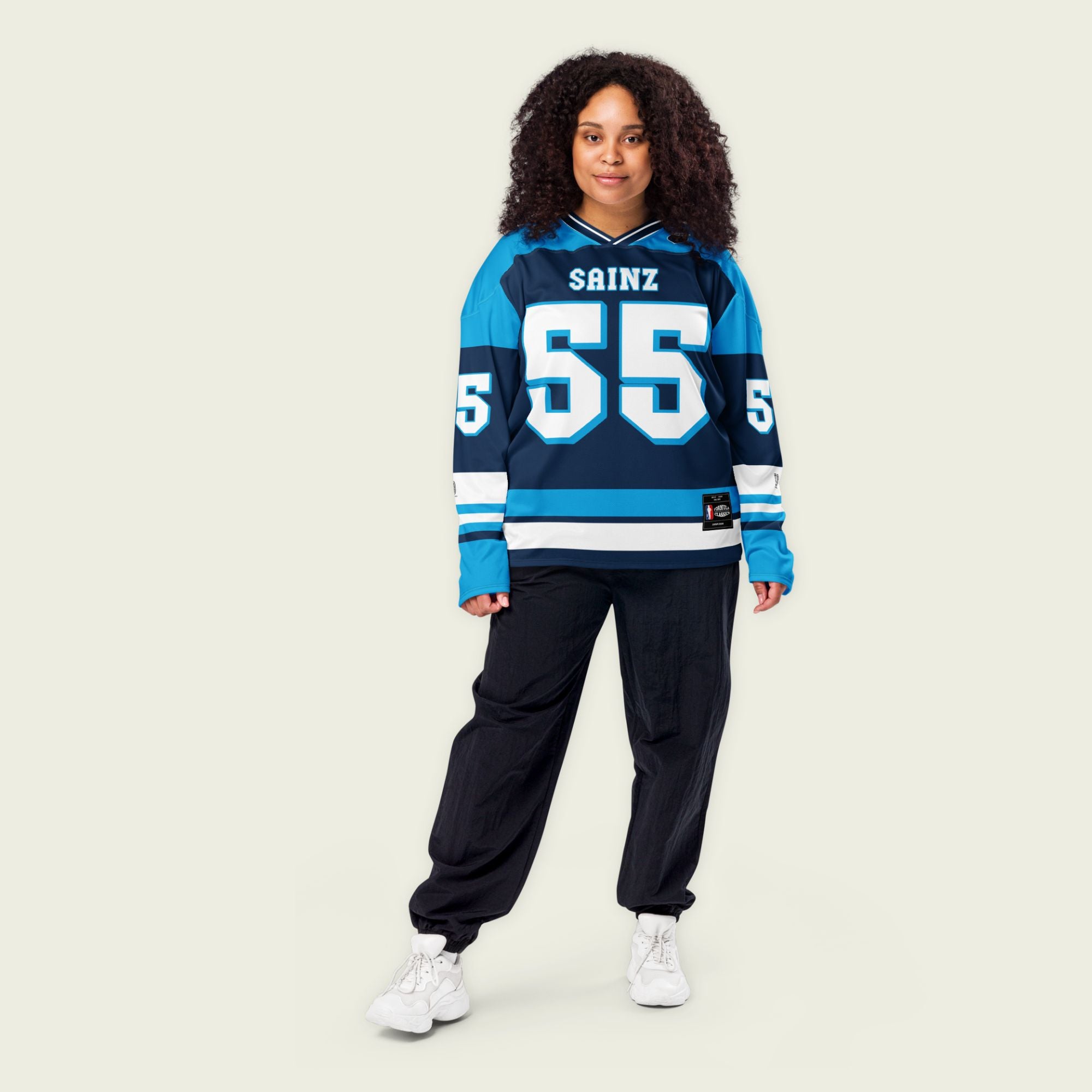A blue hockey jersey with Carlos Sainz's Williams F1 Racing number 55 in white on the front and back. It also has the name Sainz on the back and front in white.