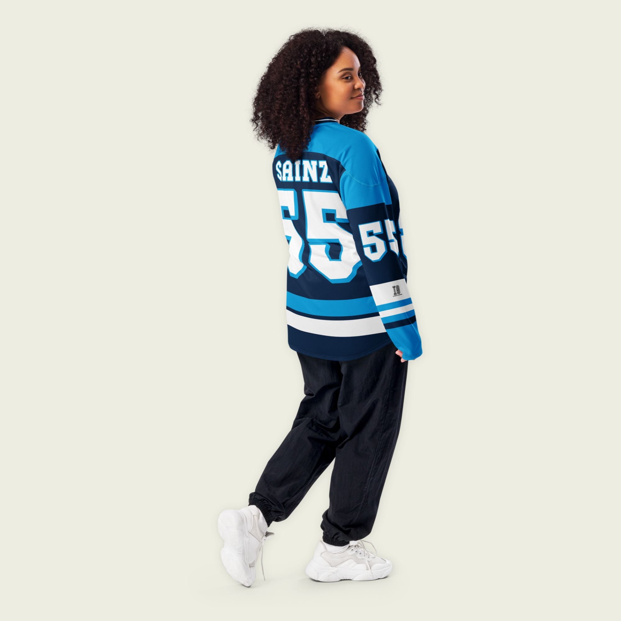A blue hockey jersey with Carlos Sainz's Williams F1 Racing number 55 in white on the front and back. It also has the name Sainz on the back and front in white.