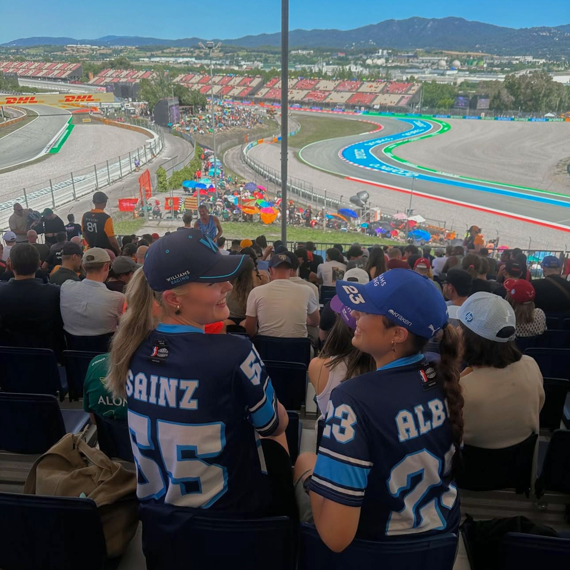 A navy blue football jersey with Carlos Sainz Jnr's WIlliams F1 racing number 55 on the back and front in white with a light blue outline.