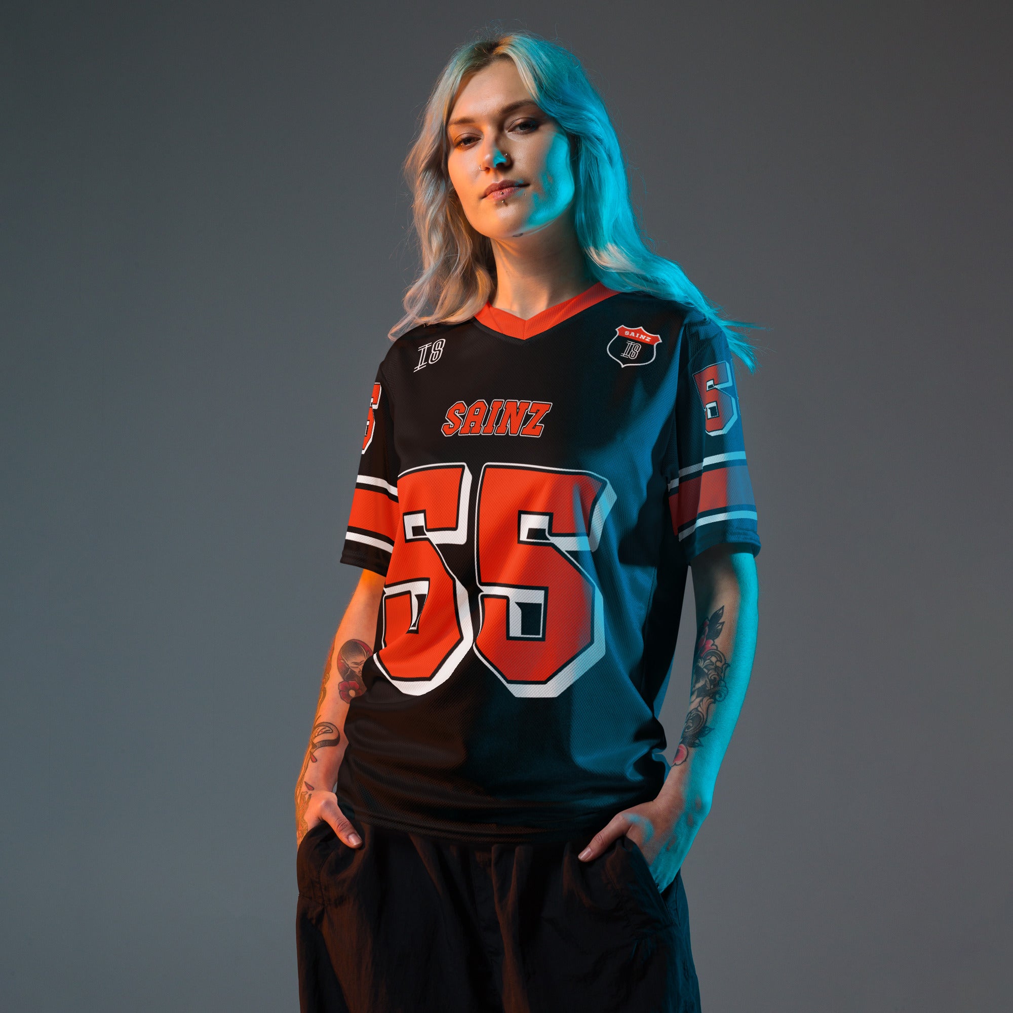 A black and red football jersey with Carlos Sainz Ferrari F1 racing number 55 in red. it has his name saizn on the front and back as well.
