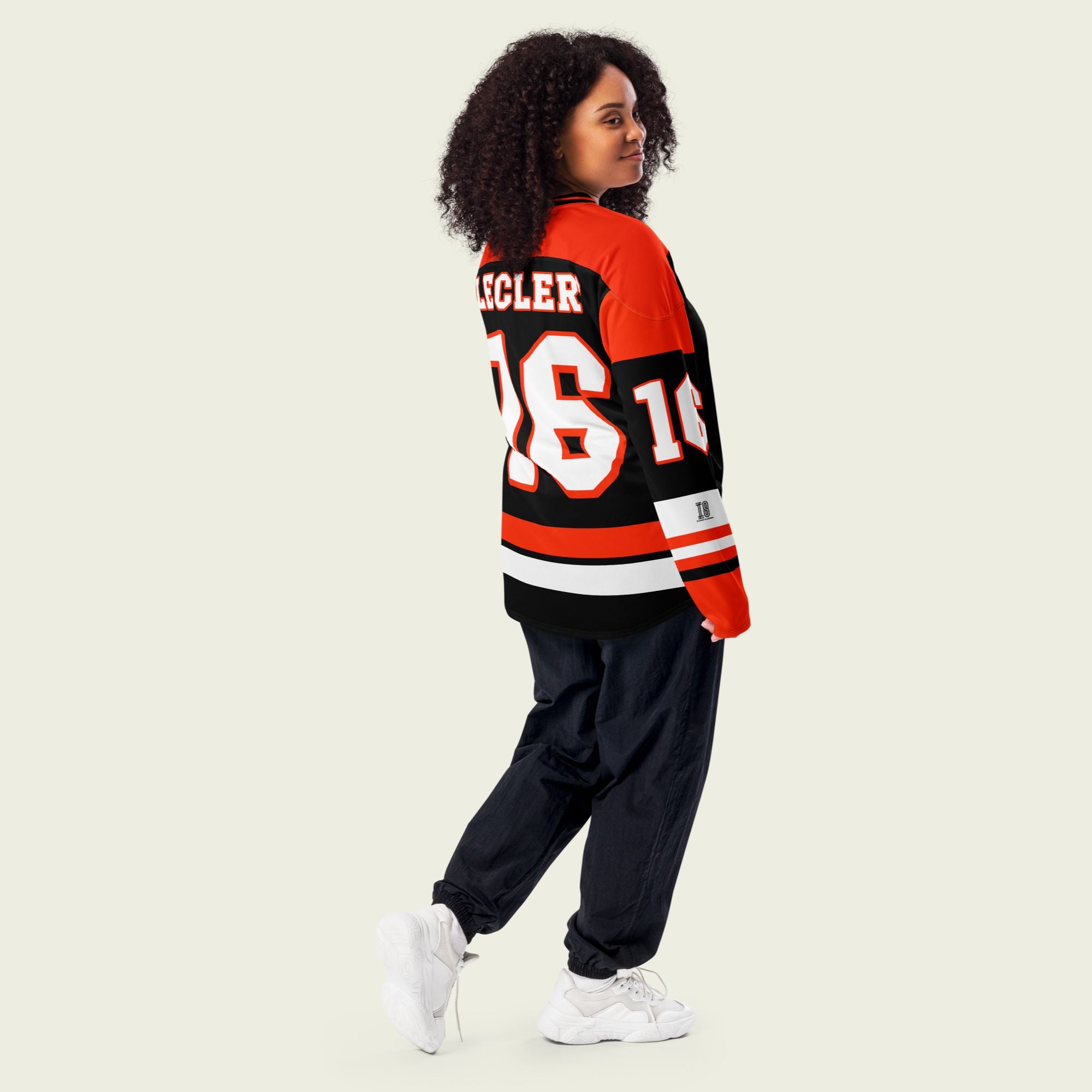 A red and black hockey jersey with Charles Leclerc's Ferrari F1 racing number 16 in white on the front and back. It has the name Leclerc on the back and front in white as well.