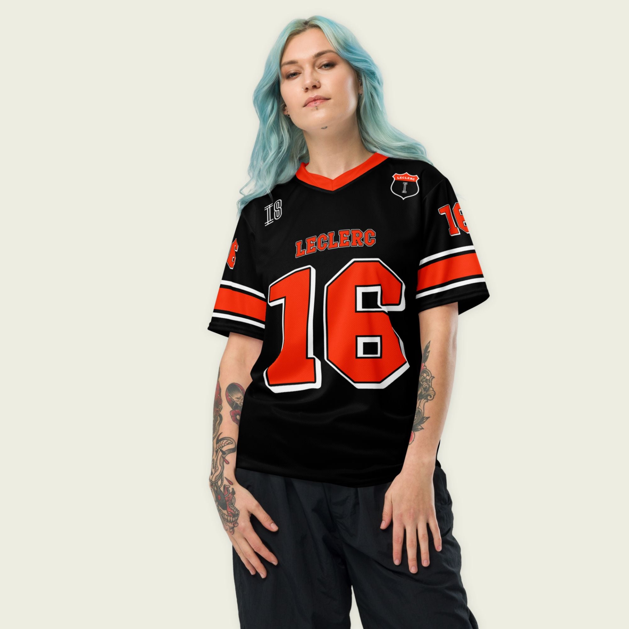 A black and red football jersey with Charles Leclerc's Ferrari F1 Racing number 16 on the front and back. The name Leclerc is on the front and back.