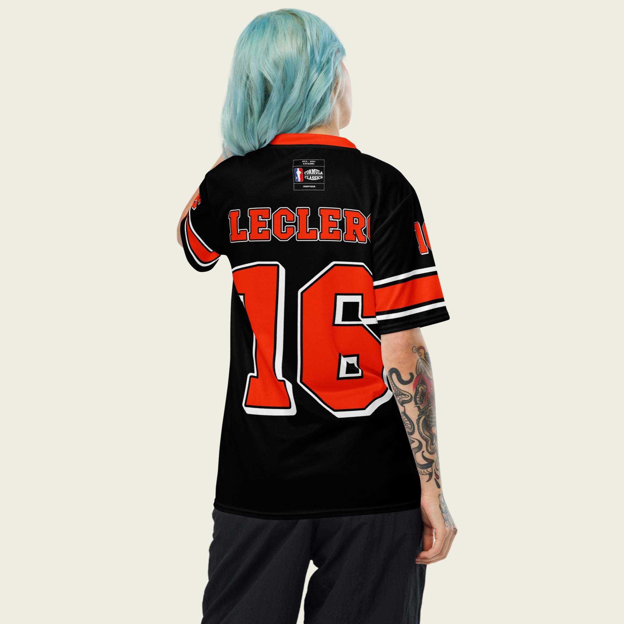 A black and red football jersey with Charles Leclerc's Ferrari F1 Racing number 16 on the front and back. The name Leclerc is on the front and back.