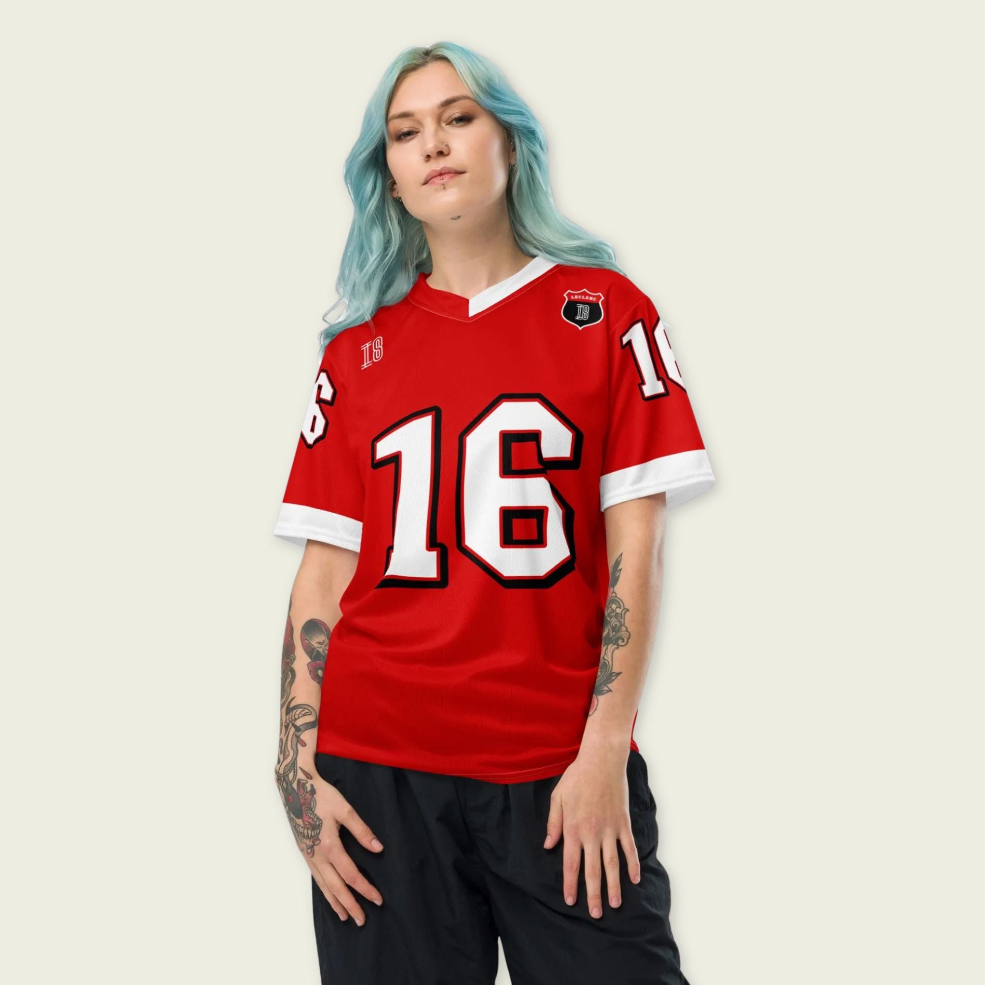 A red and white football jersey with Charles Leclerc's Ferrari  F1 racing number 16 on the back and front in white. It has the name Leclerc in black on the front and back as well.