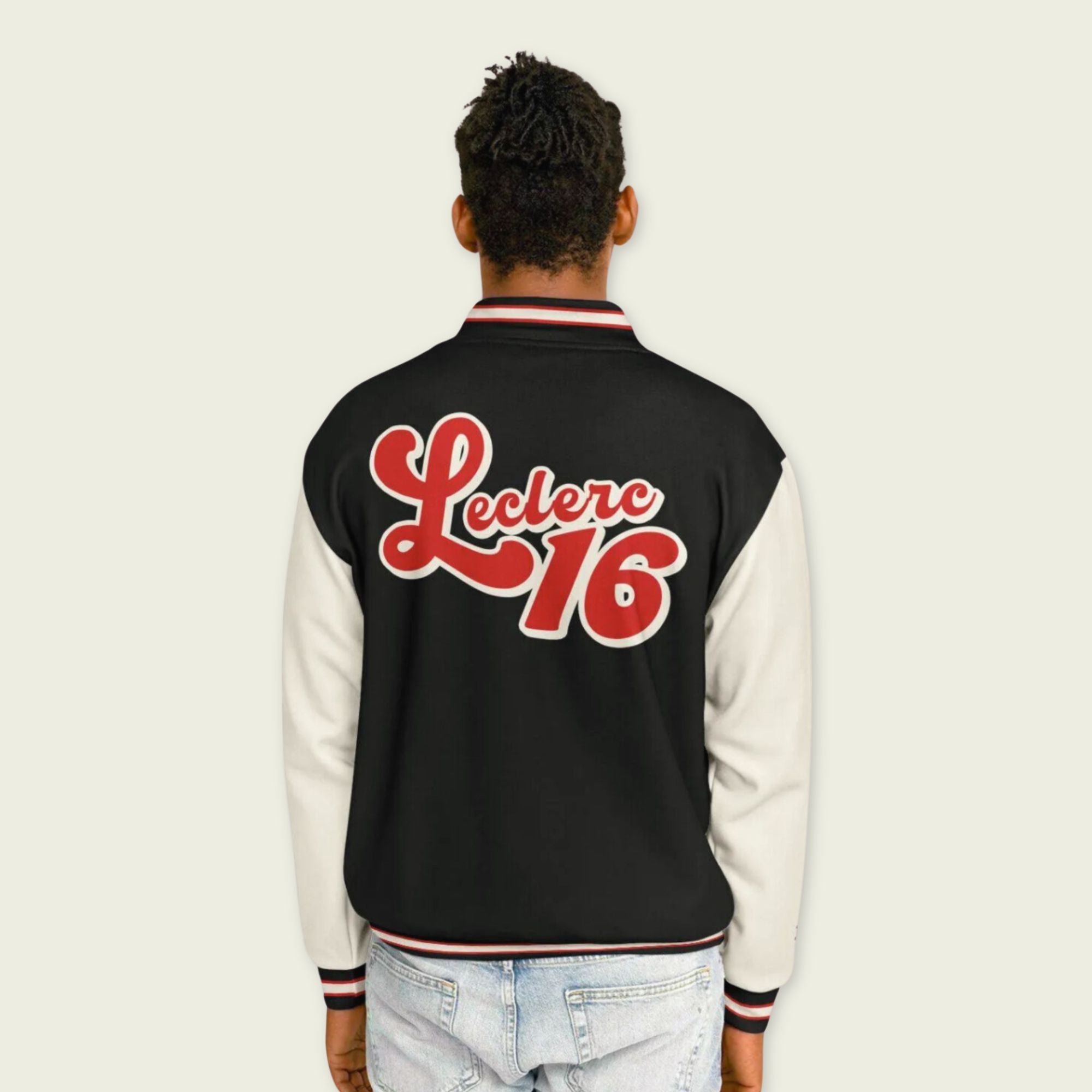 A black, red, and tan, varsity jacket with Charles Leclerc's Ferrari F1 racing number 16 in red on the front and back.