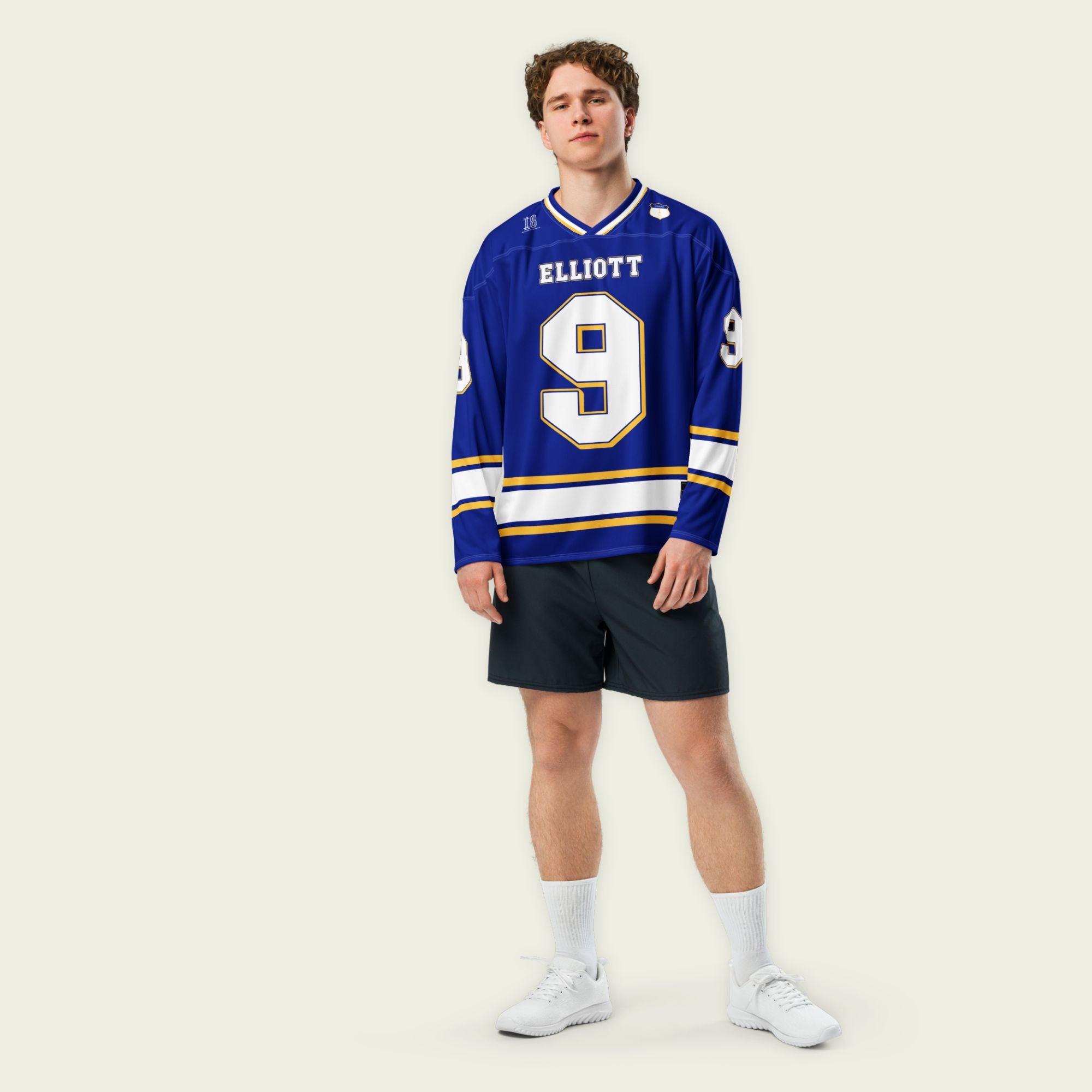 A Navy blue, white, and gold hockey jersey showing Chase Elliot's Nascar racing number 9 on the front and back with his name as well.