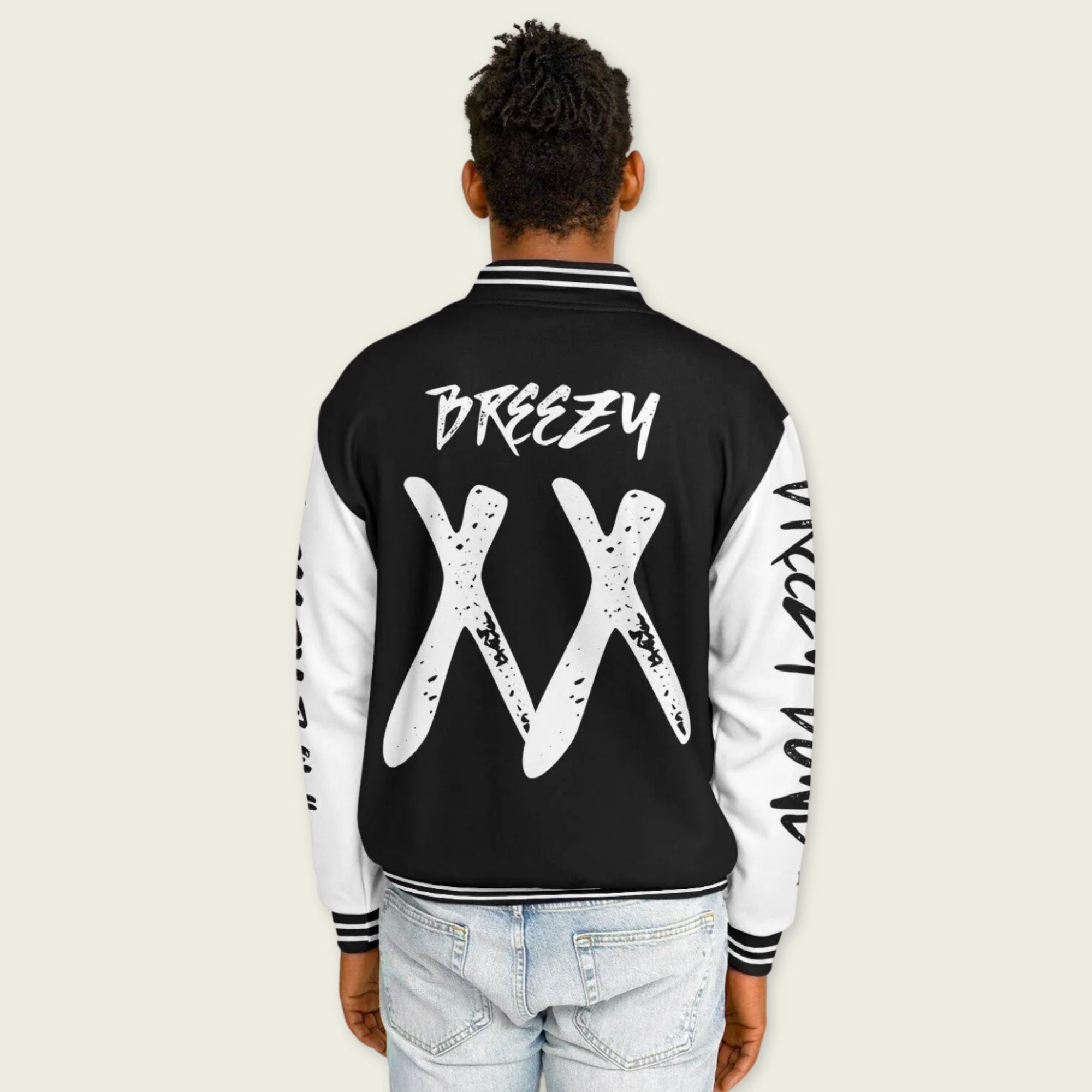 A black and white varsity jacket showing Chris Browns name Breezy on the back with XX and 11-11 breezy bowl tour