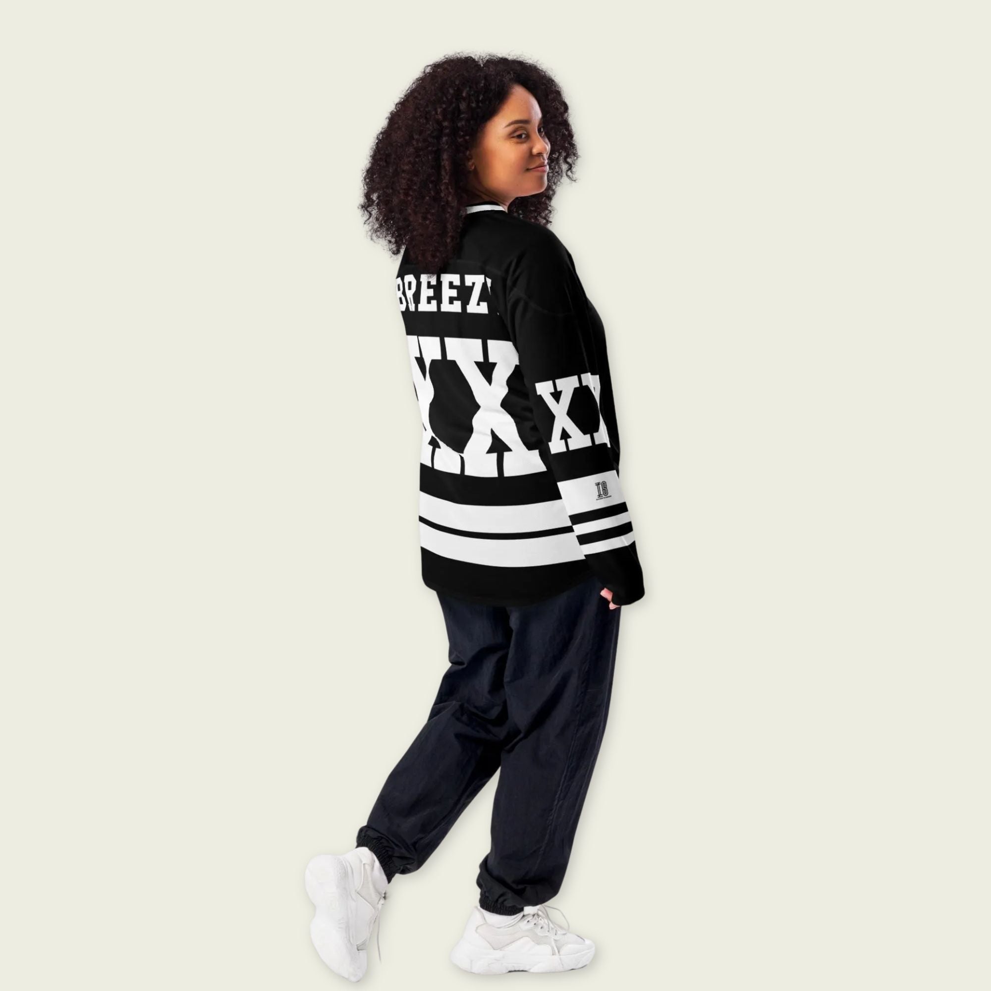 A Chris Brown Breezy Bowl Tour black and white hockey jersey with white lines showing the name Breezy on black on the back and XX on the front and back in white also.