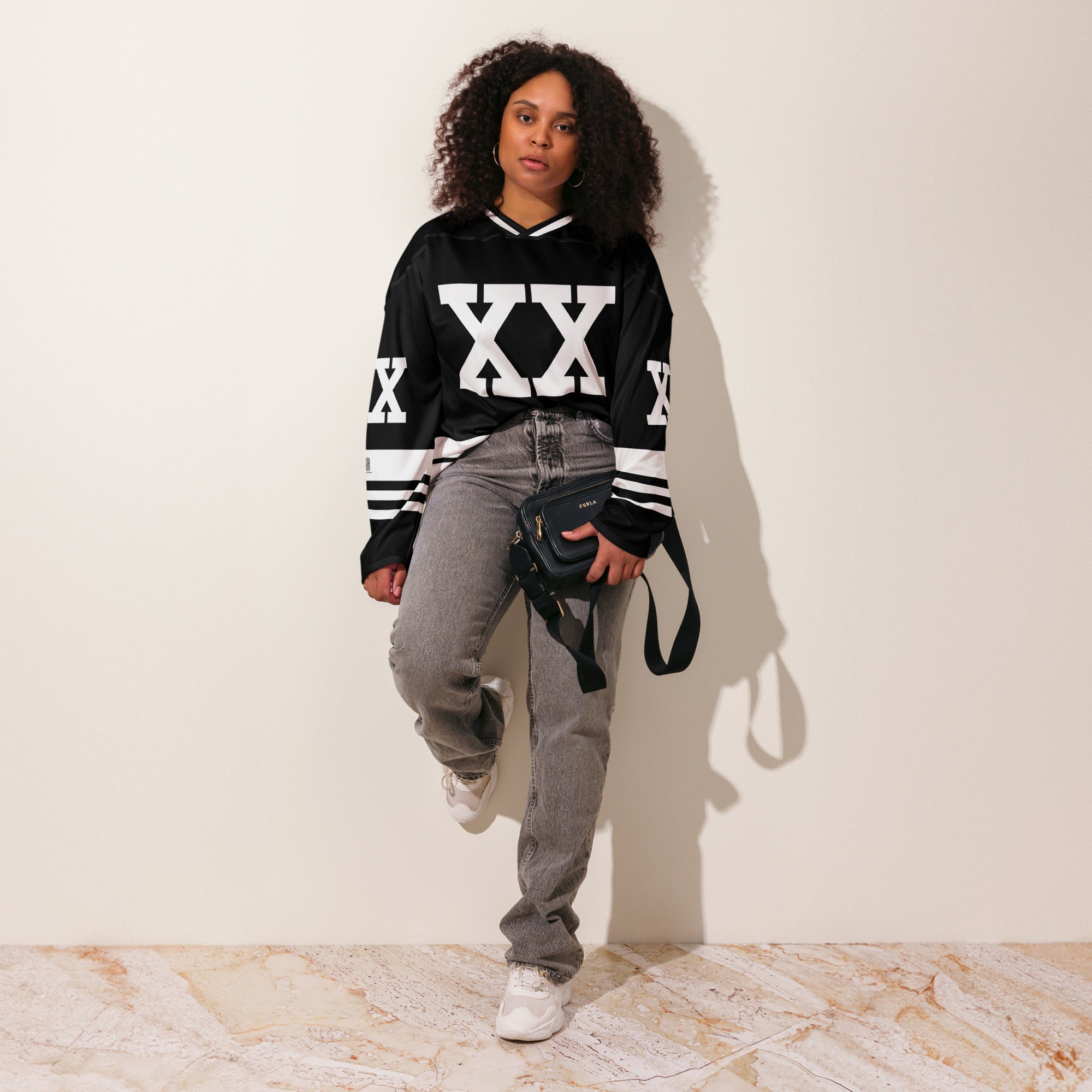 A Chris Brown Breezy Bowl Tour black and white hockey jersey with white lines showing the name Breezy on black on the back and XX on the front and back in white also.
