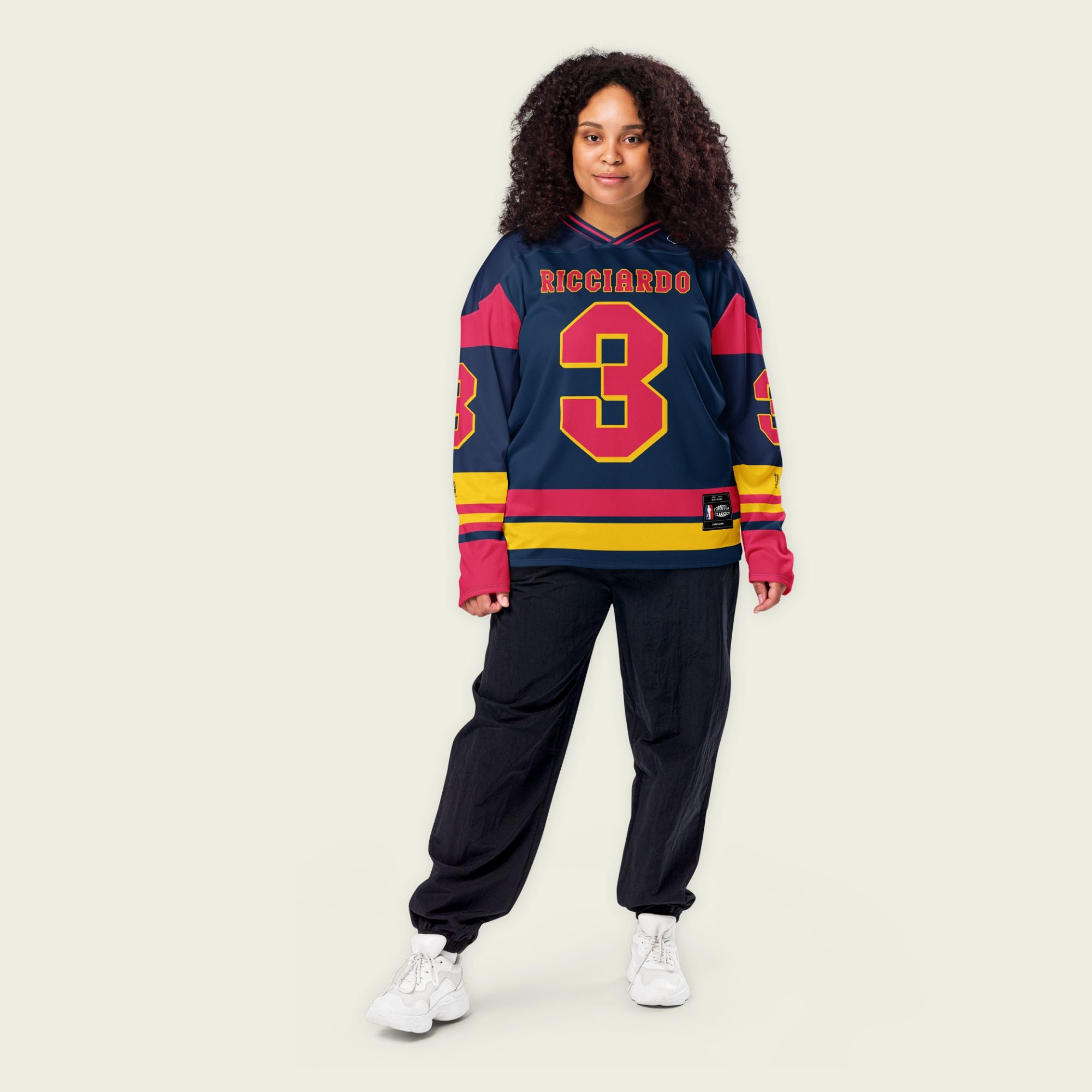 A navy blue hockey jersey with Daniel Ricciardo's Redbull F1 racing number 3 in red on the front and back. It has the name Ricciardo on the back and front in red as well.