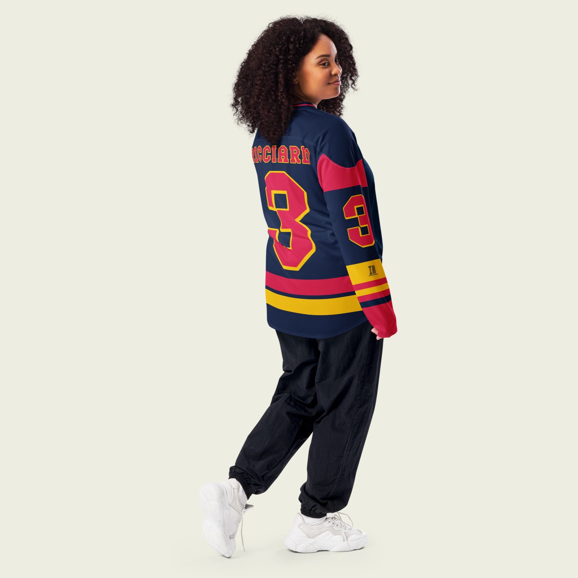 A navy blue hockey jersey with Daniel Ricciardo's Redbull F1 racing number 3 in red on the front and back. It has the name Ricciardo on the back and front in red as well.