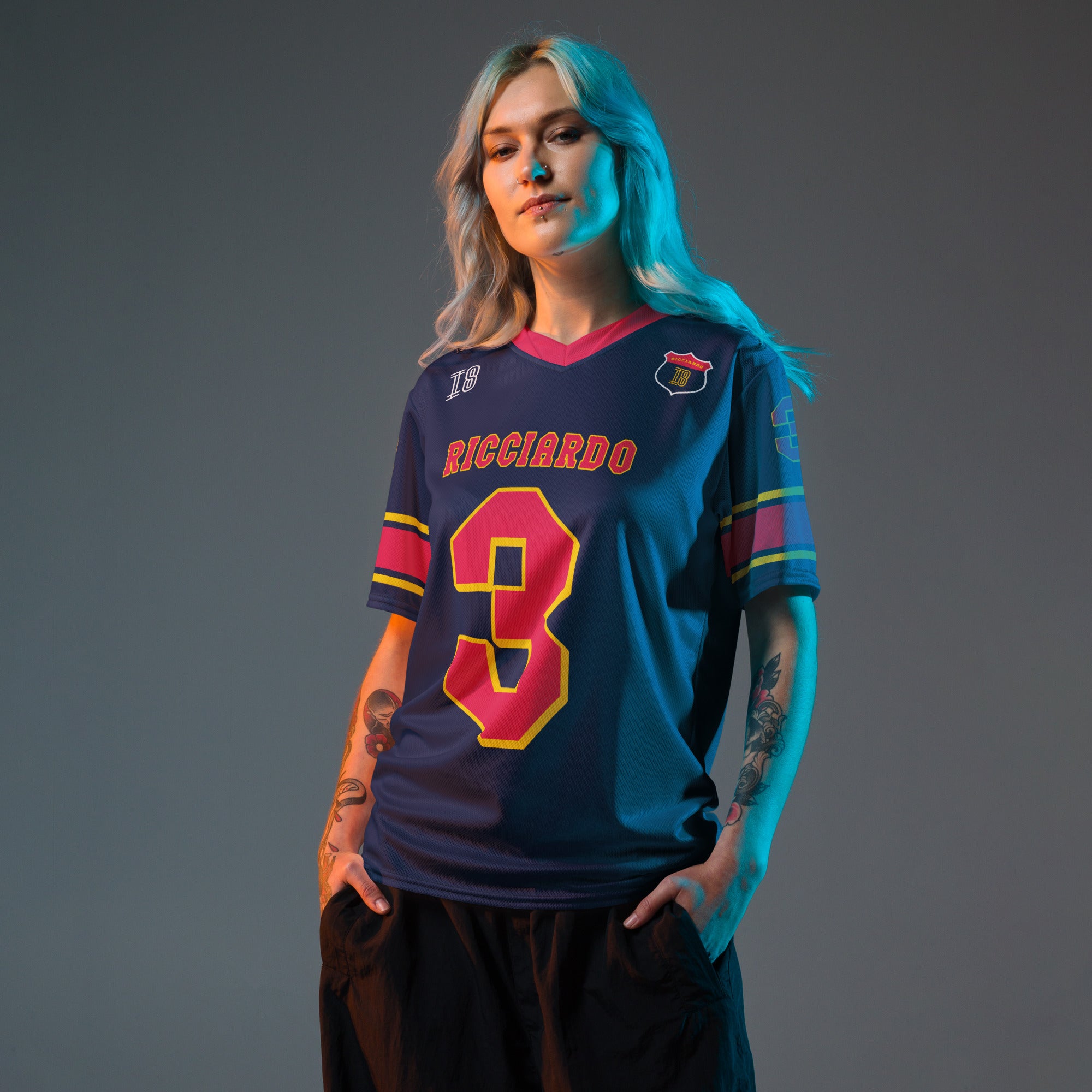 A navy blue and red football jersey with Daniel Ricciardo's Redbull F1 racing number in red on the front and back.