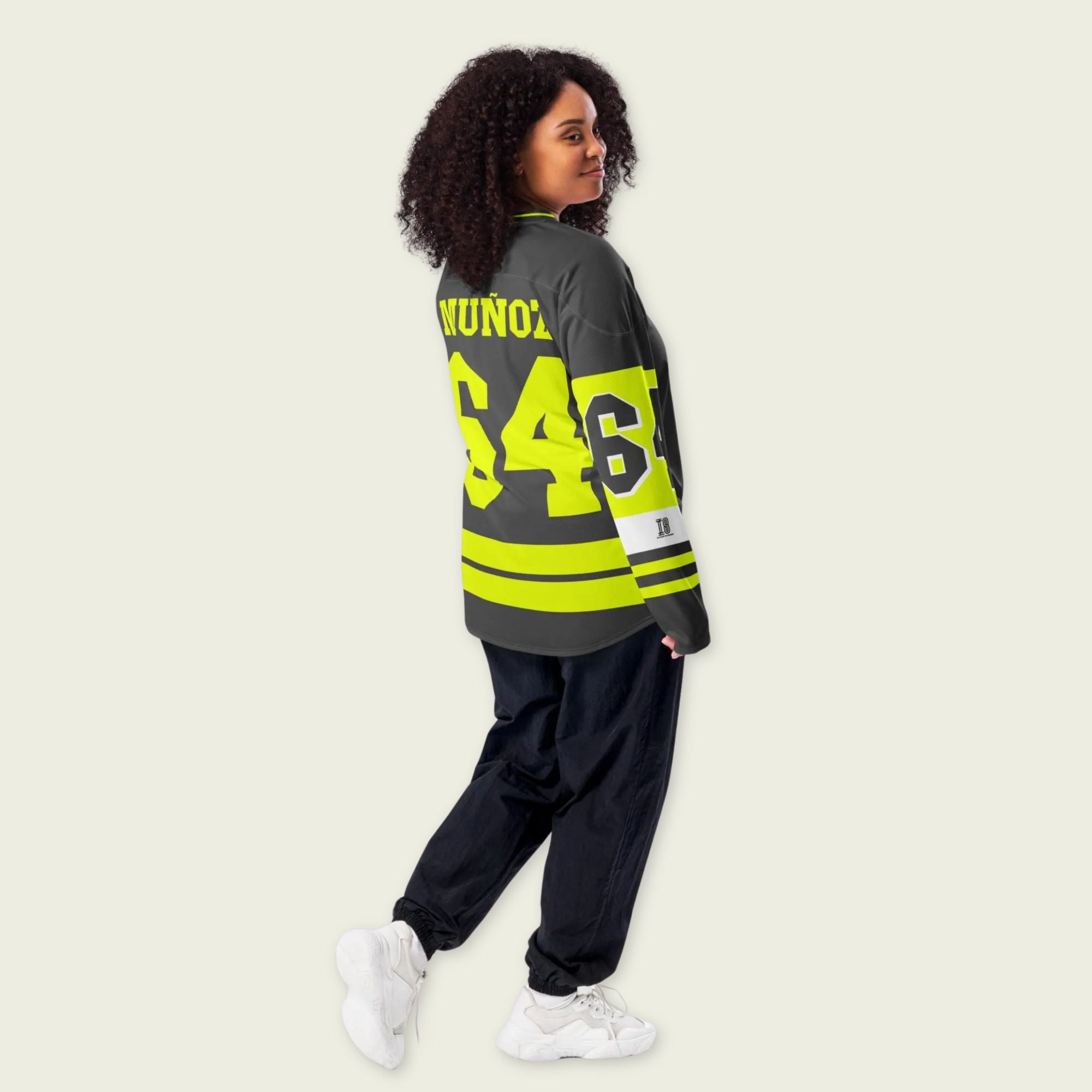 A Grey and highlight yellow hockey jersey with Daivd Munuzs name and moto gp racing number 64 on the front and back in yellow.