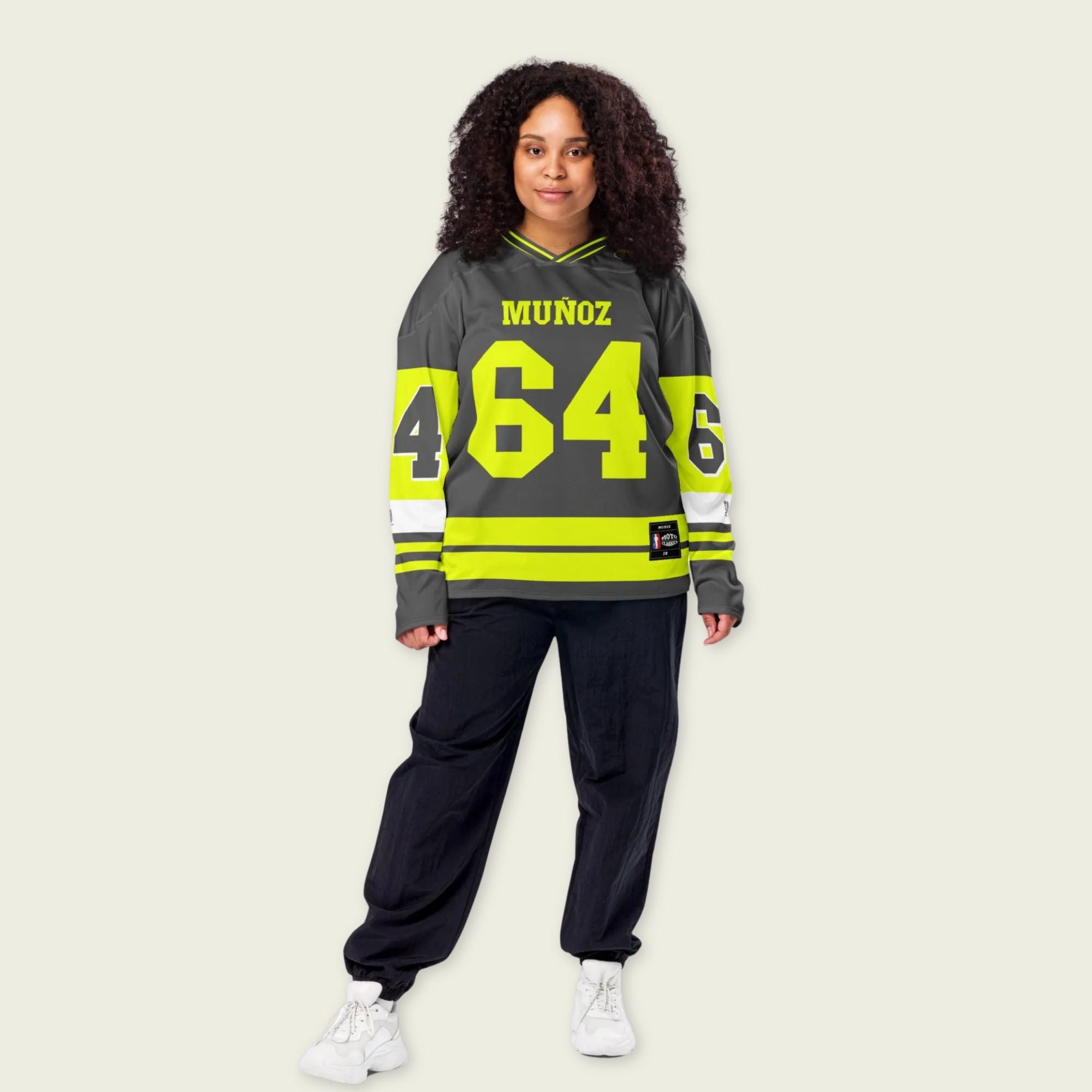A Grey and highlight yellow hockey jersey with Daivd Munuzs name and moto gp racing number 64 on the front and back in yellow.