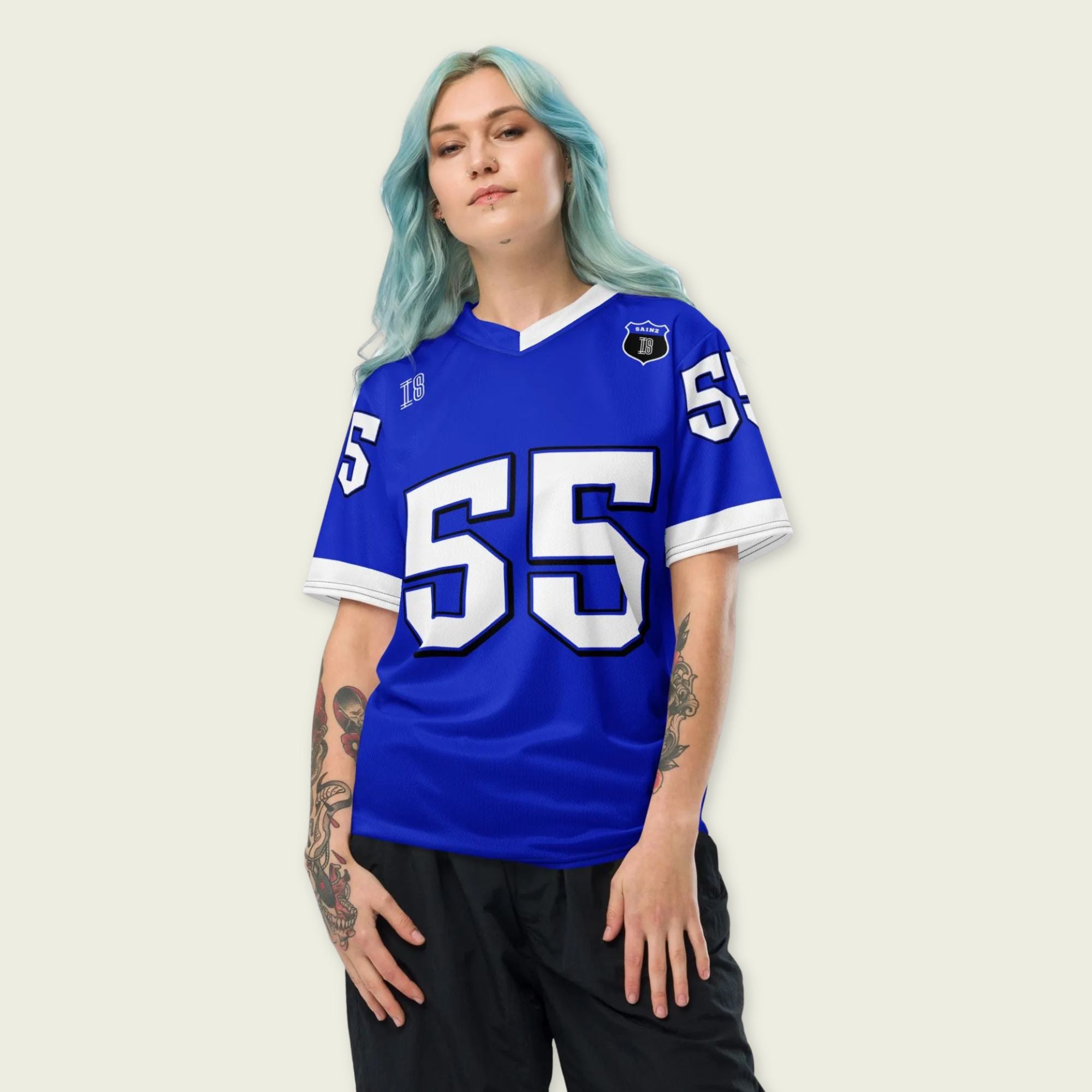 A blue and white football jersey with Carlos Sainz's Williams F1 racing number 55 on the back and front in white. It has the name sainz in white on the front and back as well.