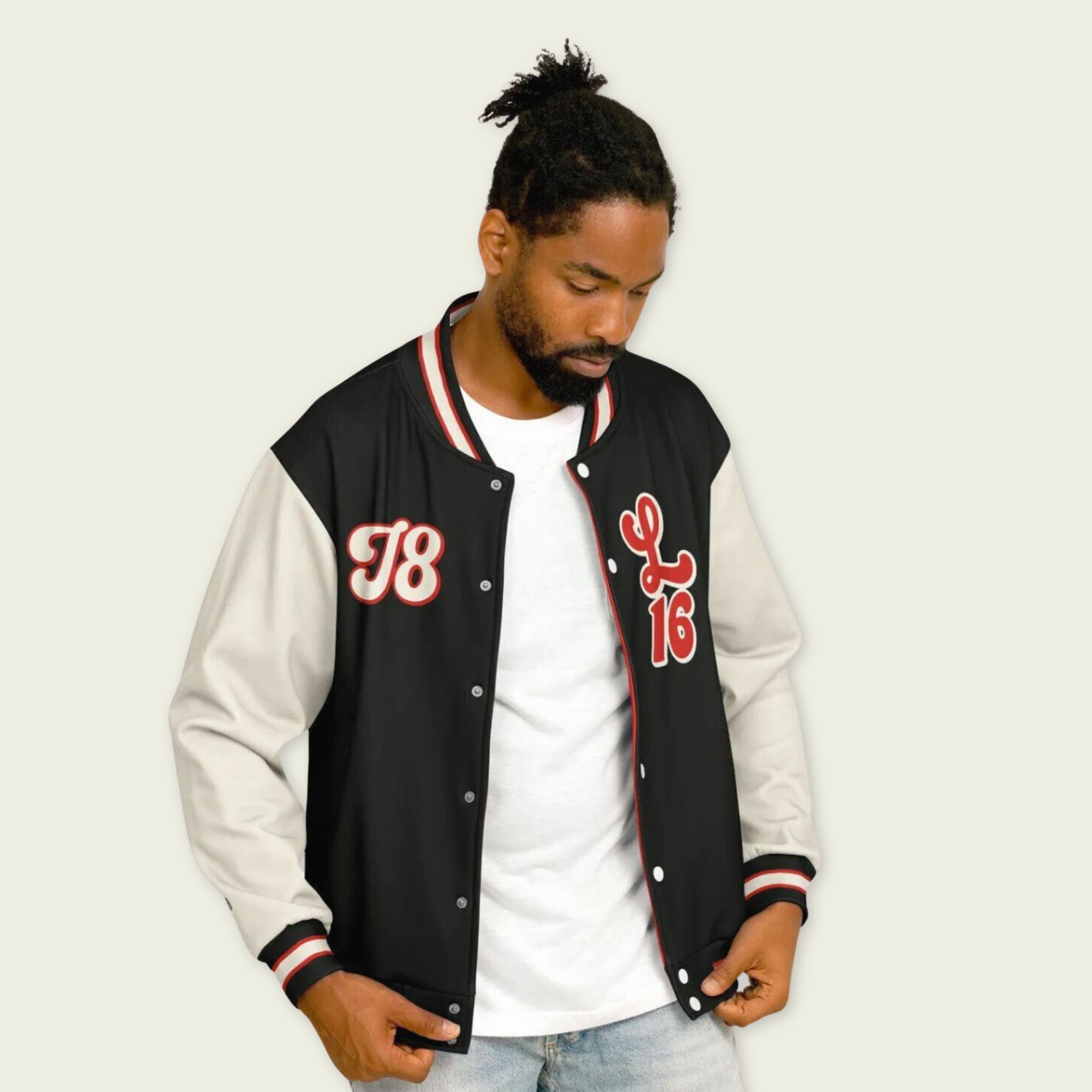 A black, red, and tan, varsity jacket with Charles Leclerc's Ferrari F1 racing number 16 in red on the front and back.