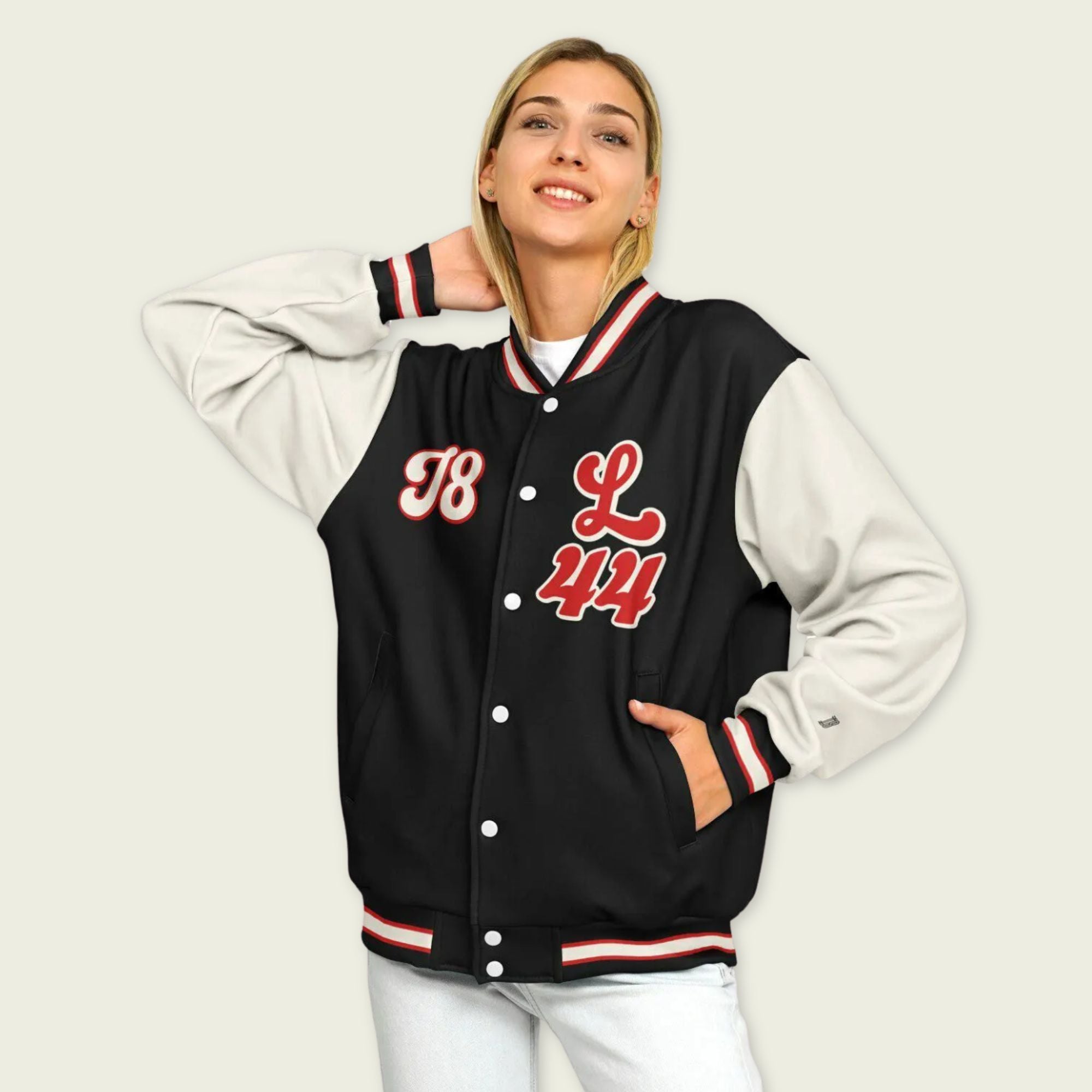 A black, red, and tan, varsity jacket with Lewis Hamilton's Ferrari F1 racing number 44 in red on the front and back.