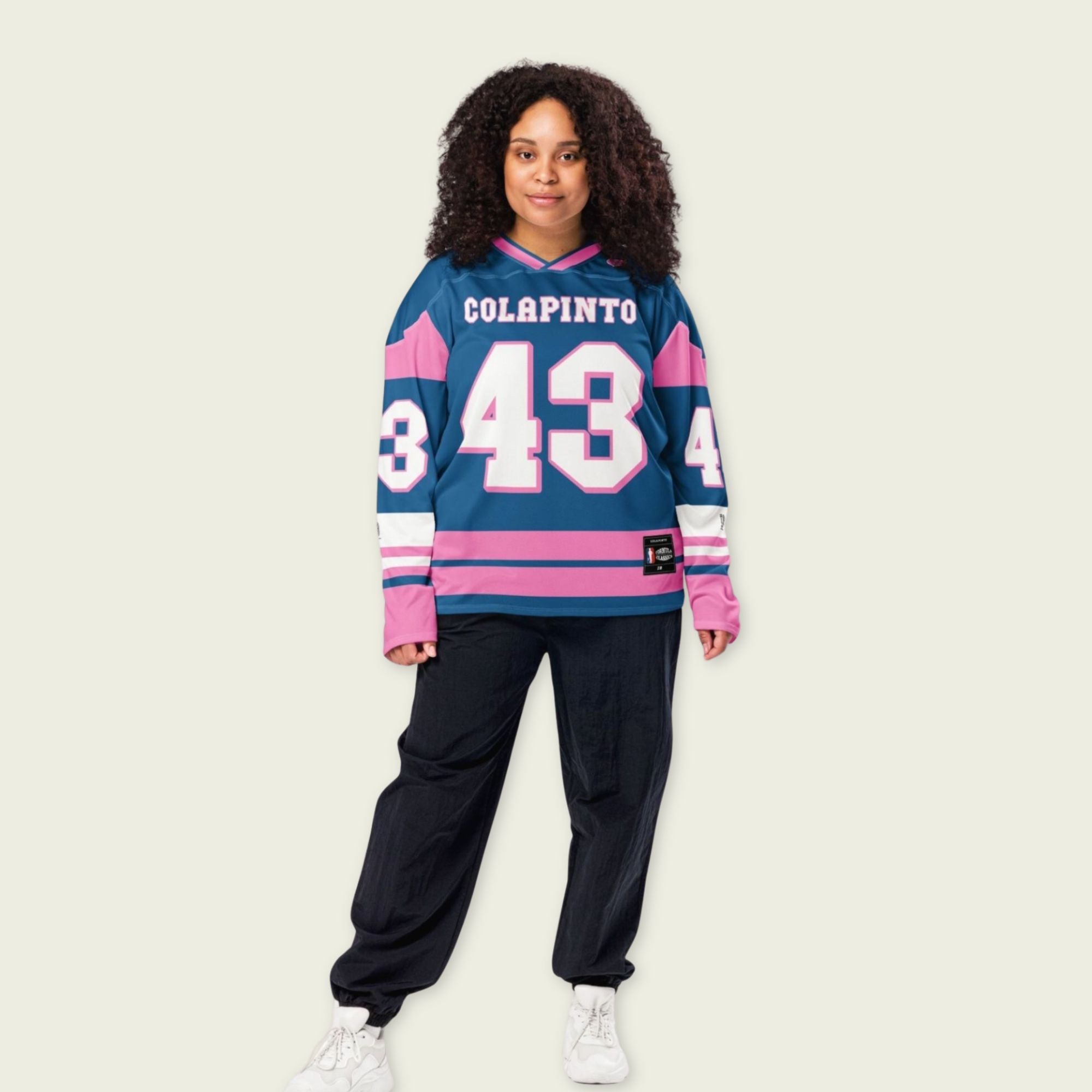 A navy blue and pink hockey jersey with Franco Colapinto's Alpine's F1 Racing number 43 in white on the front and back.