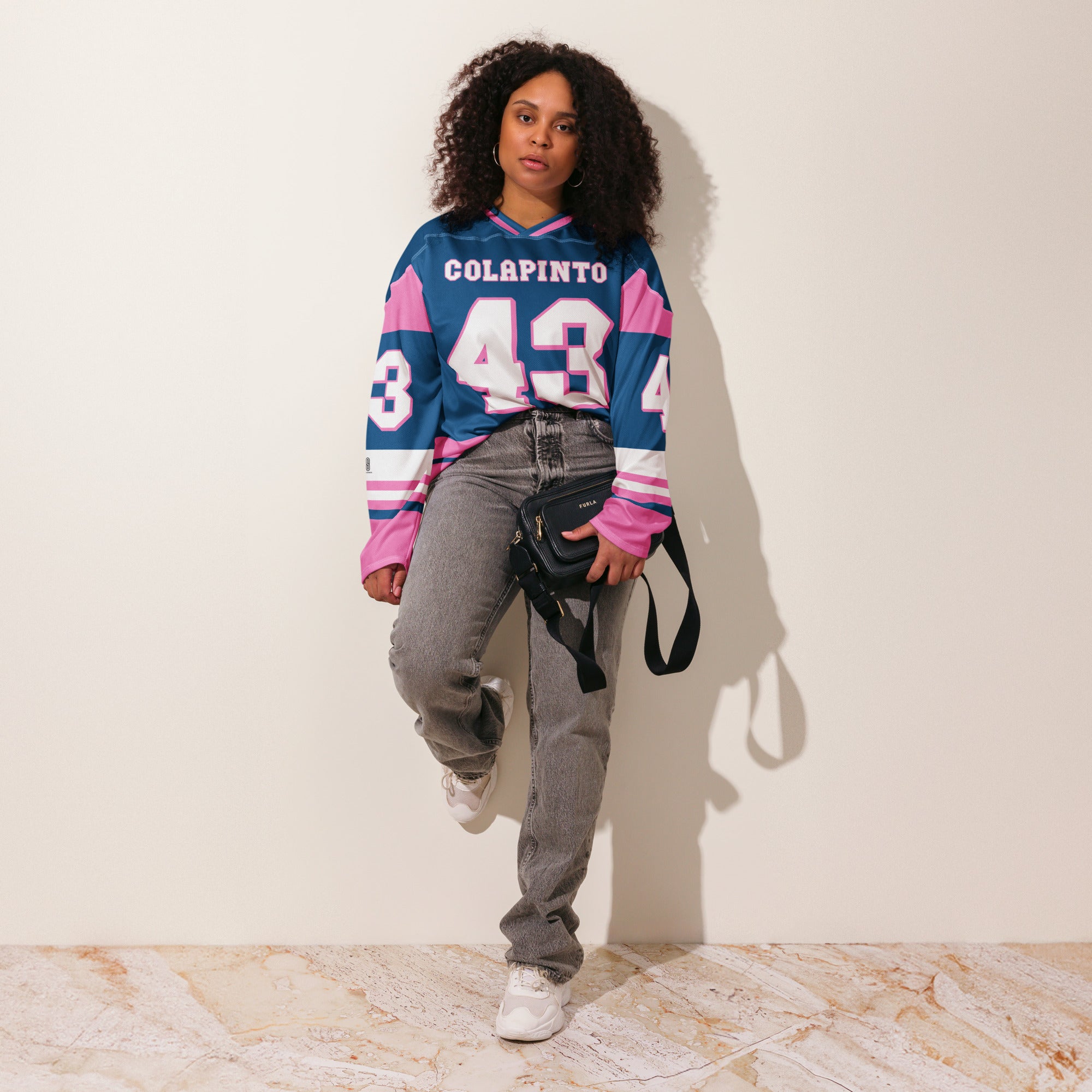 A navy blue and pink hockey jersey with Franco Colapinto's Alpine's F1 Racing number 43 in white on the front and back.
