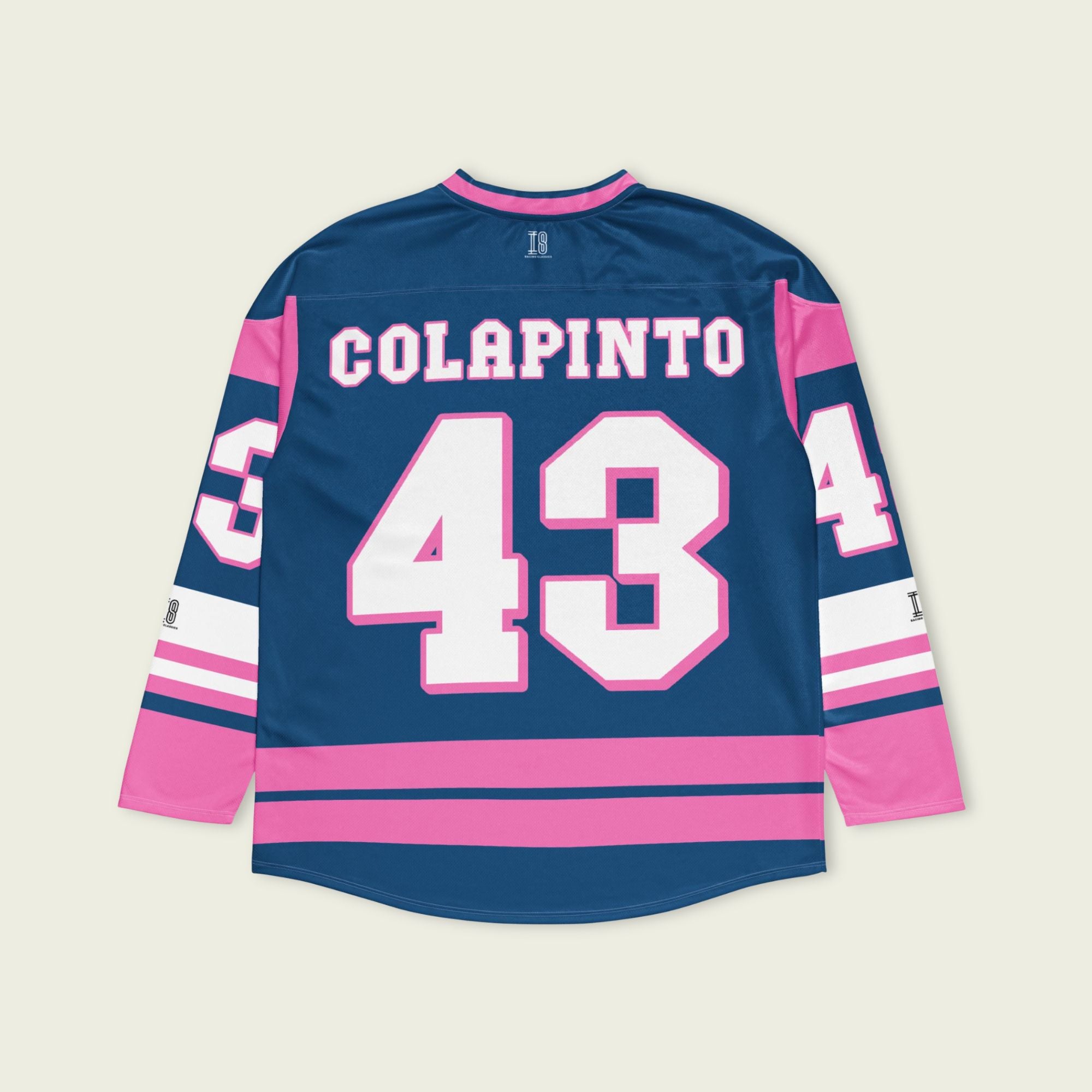 A navy blue and pink hockey jersey with Franco Colapinto's Alpine's F1 Racing number 43 in white on the front and back.