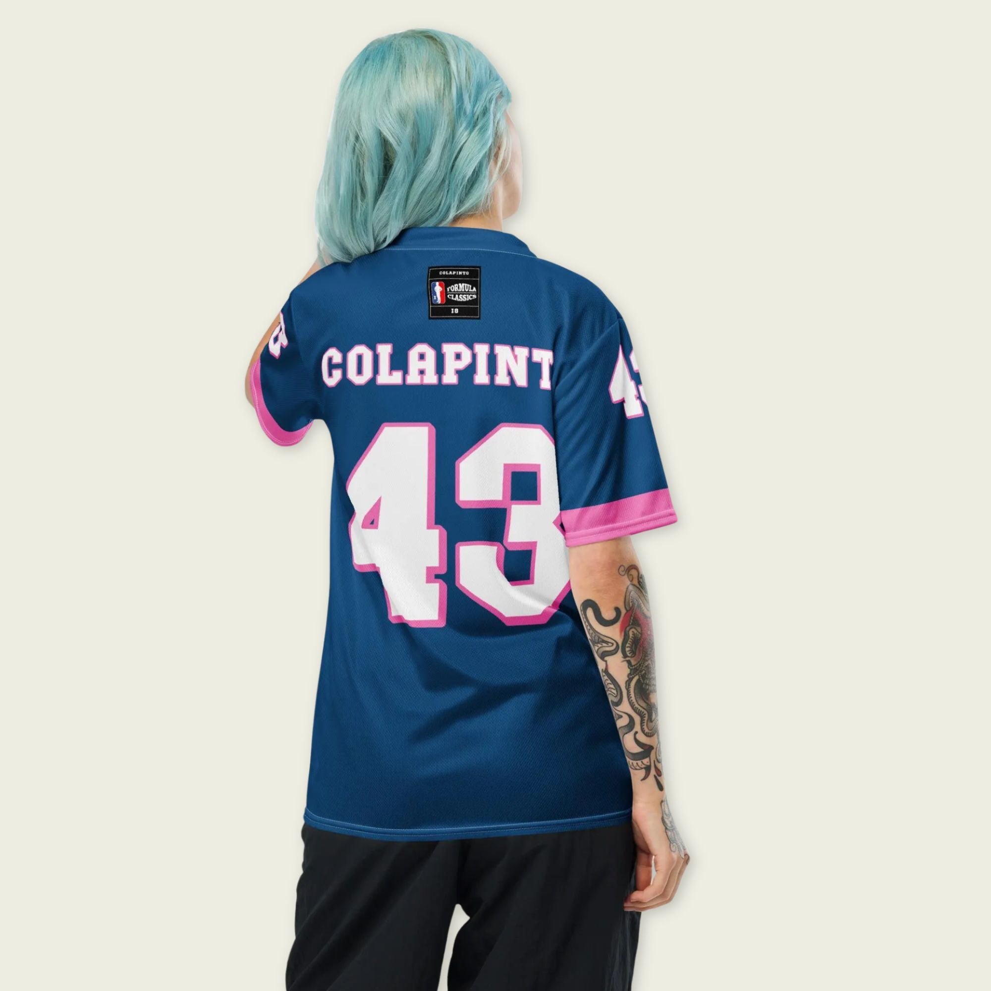 A navy blue and pink football jersey with Franco Colapinto's Alpine F1 Racing number 43 in white on the front and back.