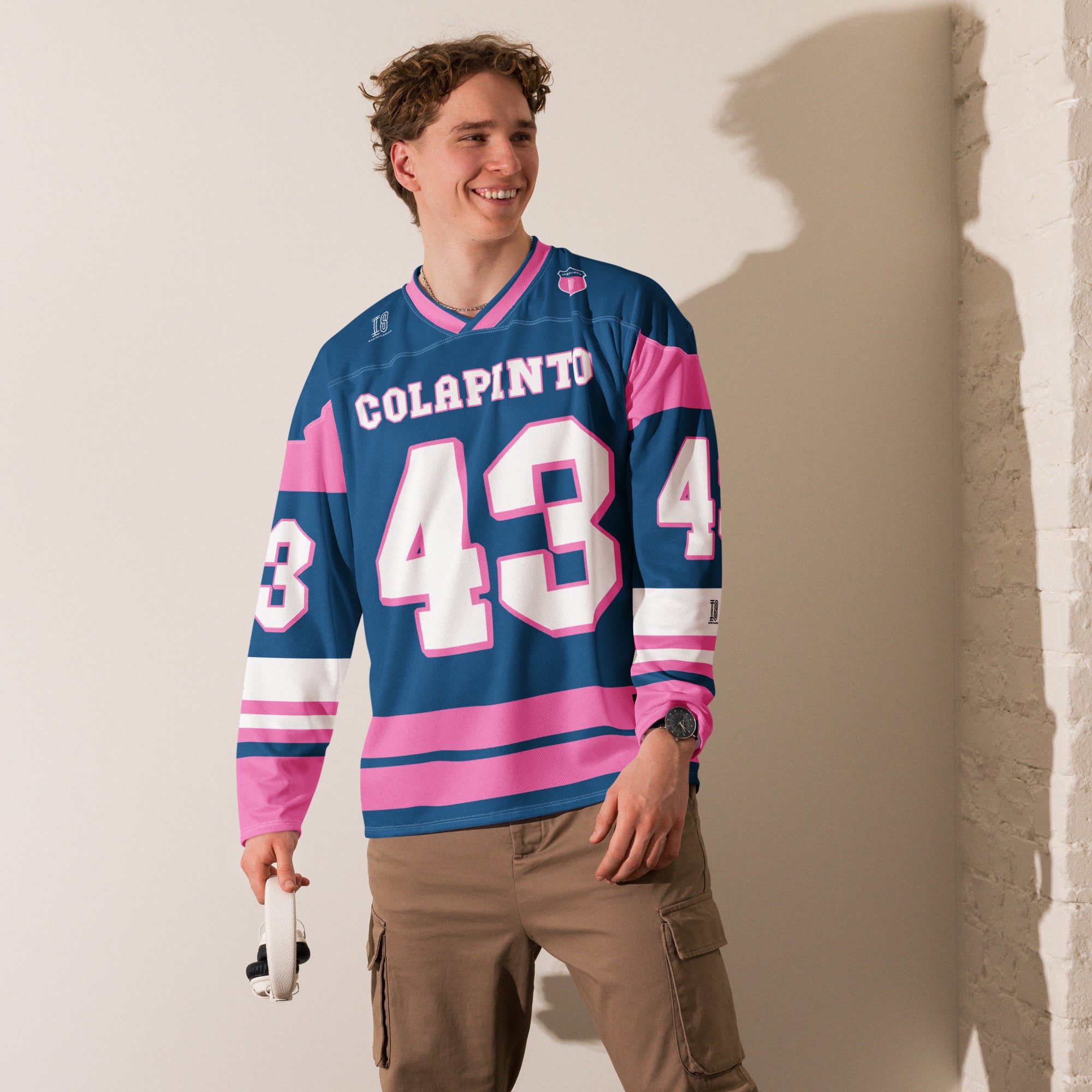 A navy blue and pink hockey jersey with Franco Colapinto's Alpine's F1 Racing number 43 in white on the front and back.