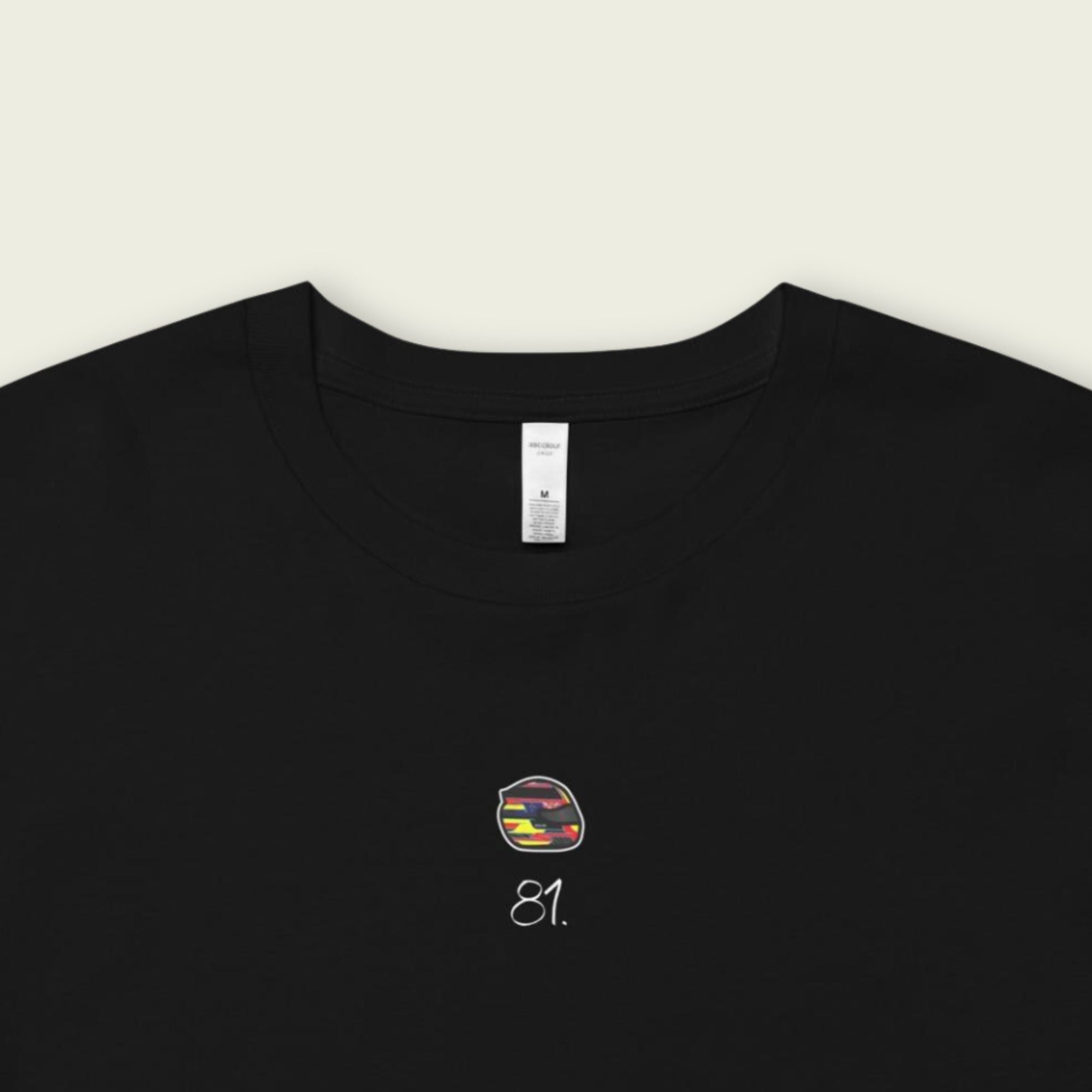 Black t-shirt with a colorful logo and text on a beige background