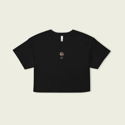 Black crop top with a small graphic on a beige background