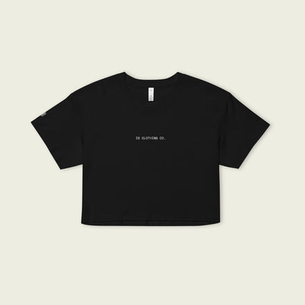 Black crop top with 'DR CLOTHING CO.' text on a beige background