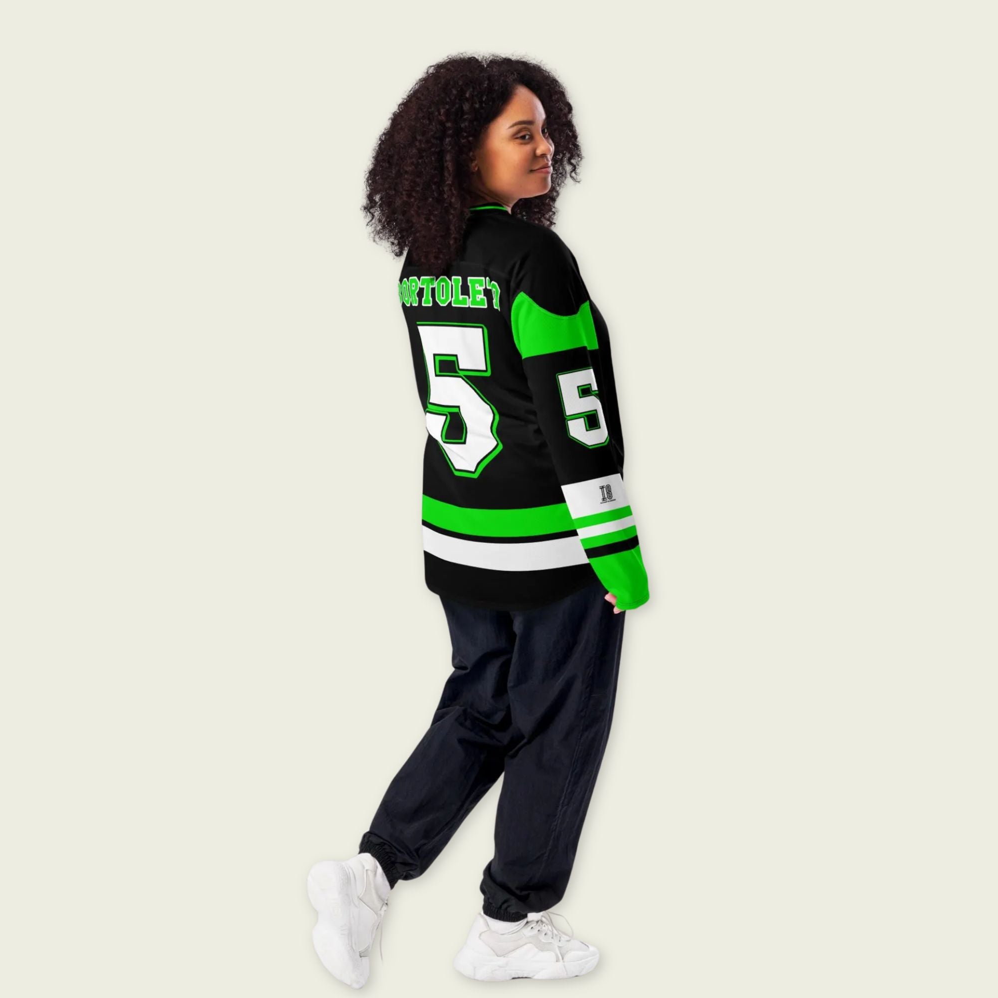 A green and black hockey jersey with Gabriel Bortoleto's Kick Stake F1 racing number 5 in green on the front and back. It has the name Gabriel Bortoleto on the back and front in green as well.