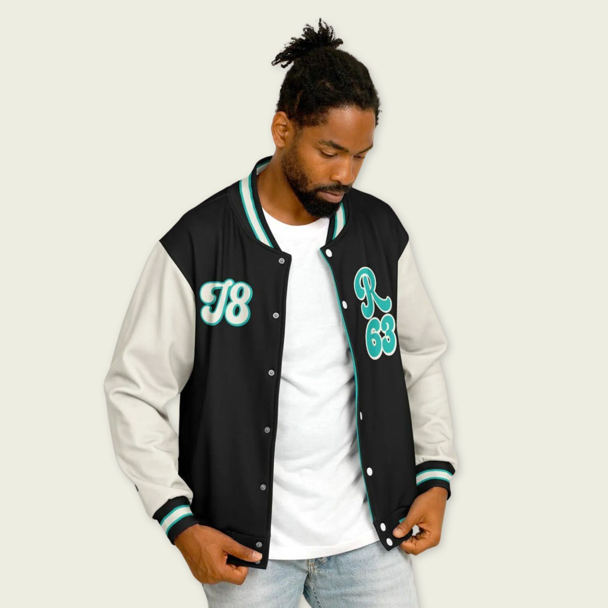 A navy petronas green, black, and tan, varsity jacket with George Russll's Mercedes F1 racing number 63 in green on the front and back.
