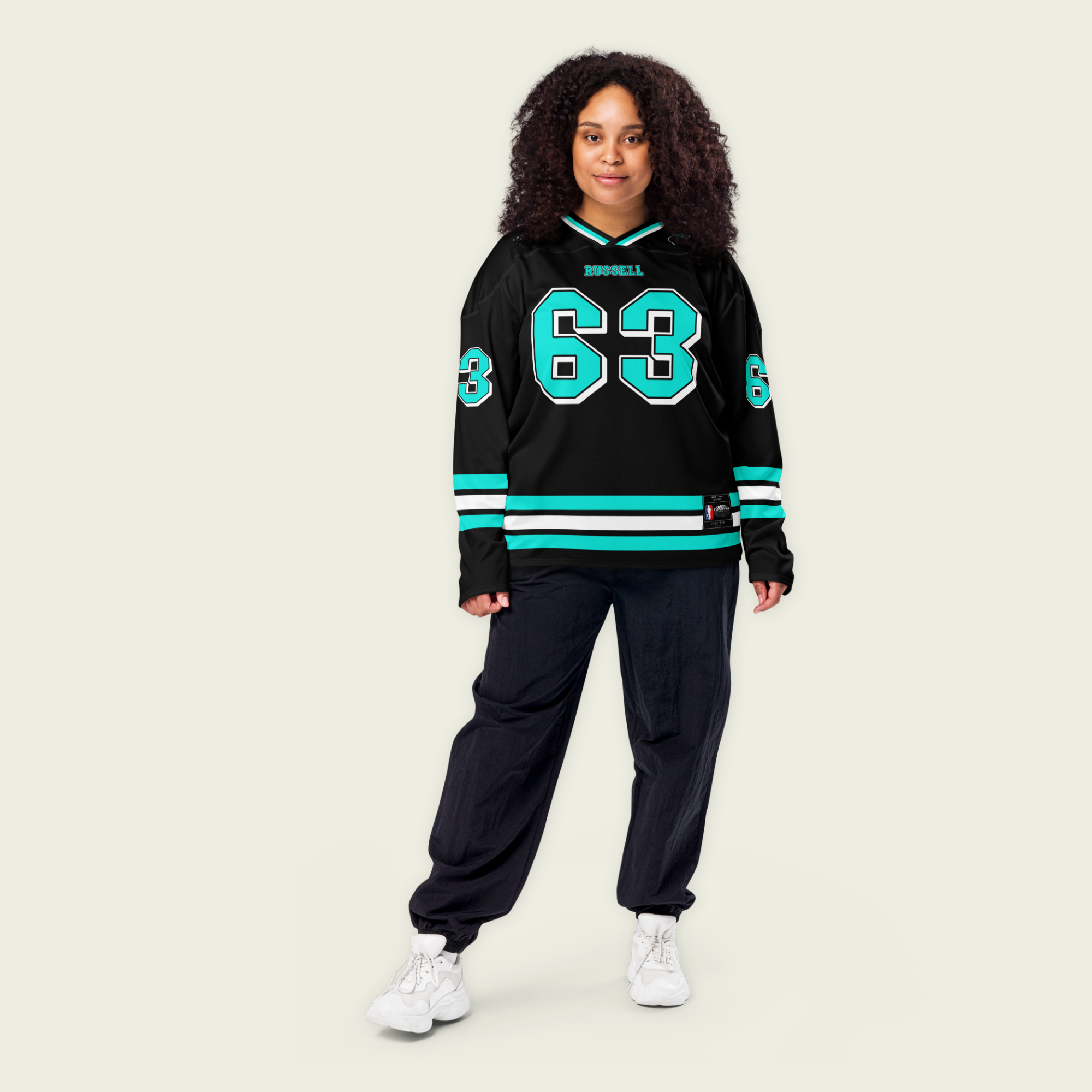 A black hockey jersey with george russells f1 racing number 63 on the front and back in mercedes green. His name Russell is on the front in back as well in turquoise.