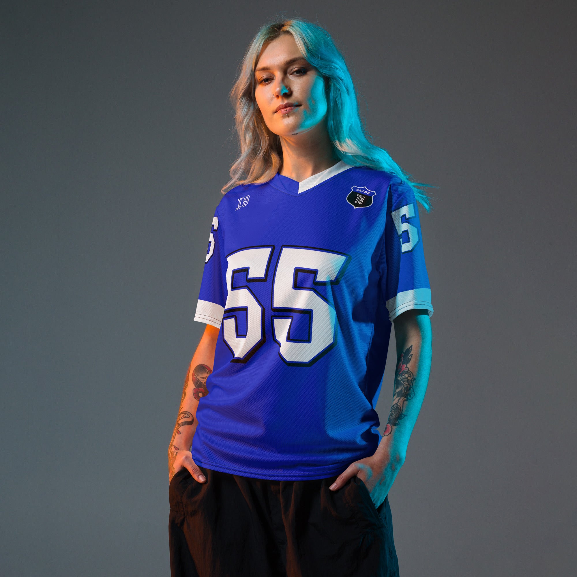 A blue and white football jersey with Carlos Sainz's Williams F1 racing number 55 on the back and front in white. It has the name sainz in white on the front and back as well.