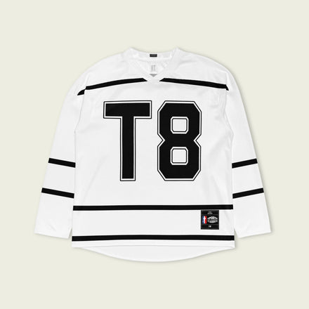 A Tate Mcrae white hockey jersey with black lines showing the name Mcrae in black on the back and T8 on the front.