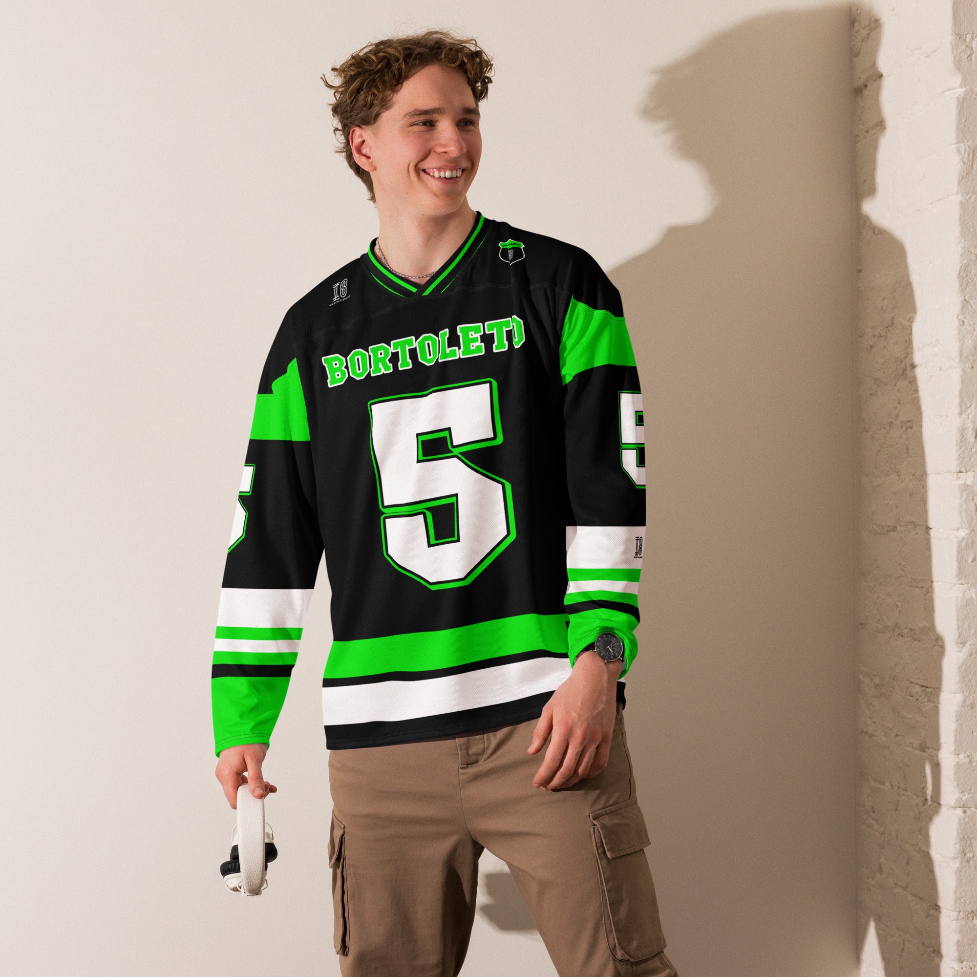 A green and black hockey jersey with Gabriel Bortoleto's Kick Stake F1 racing number 5 in green on the front and back. It has the name Gabriel Bortoleto on the back and front in green as well.