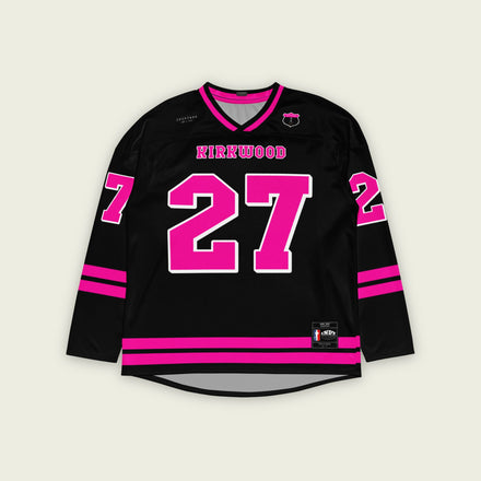 A black hockey jersey with pink stripes on the bottom and the armes, with Kyle Kirkwood's indycar racing number 27 on the arms, back, and front. The jersey also has the name kirkwood displayed on the front and back.
