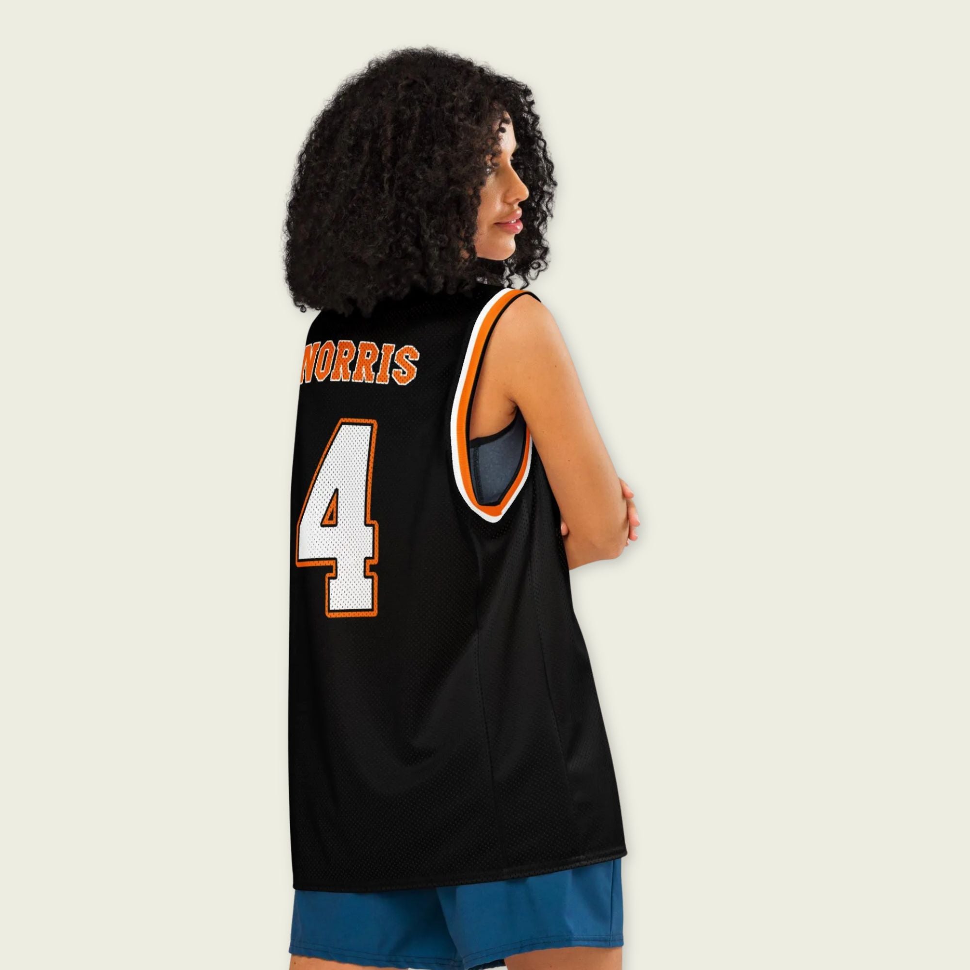 A black and papaya orange basketball Jersey with Lando Norris's McLaren F1 racing number 4 in orange and white on the front and back.