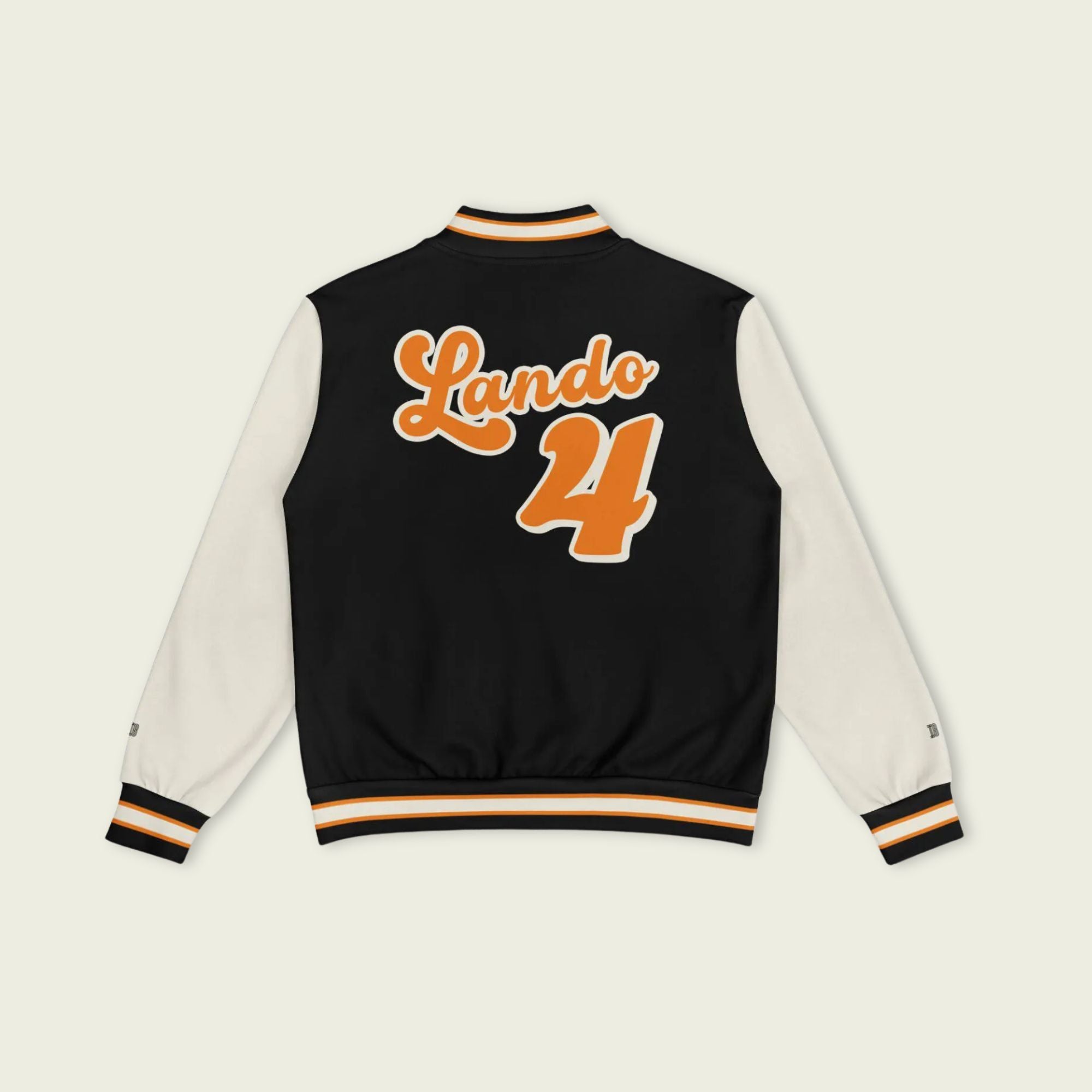 A black, papaya orange, and tan, varsity jacket with Oscar Piastri's McLaren F1 racing number 81 in orange on the front and back.
